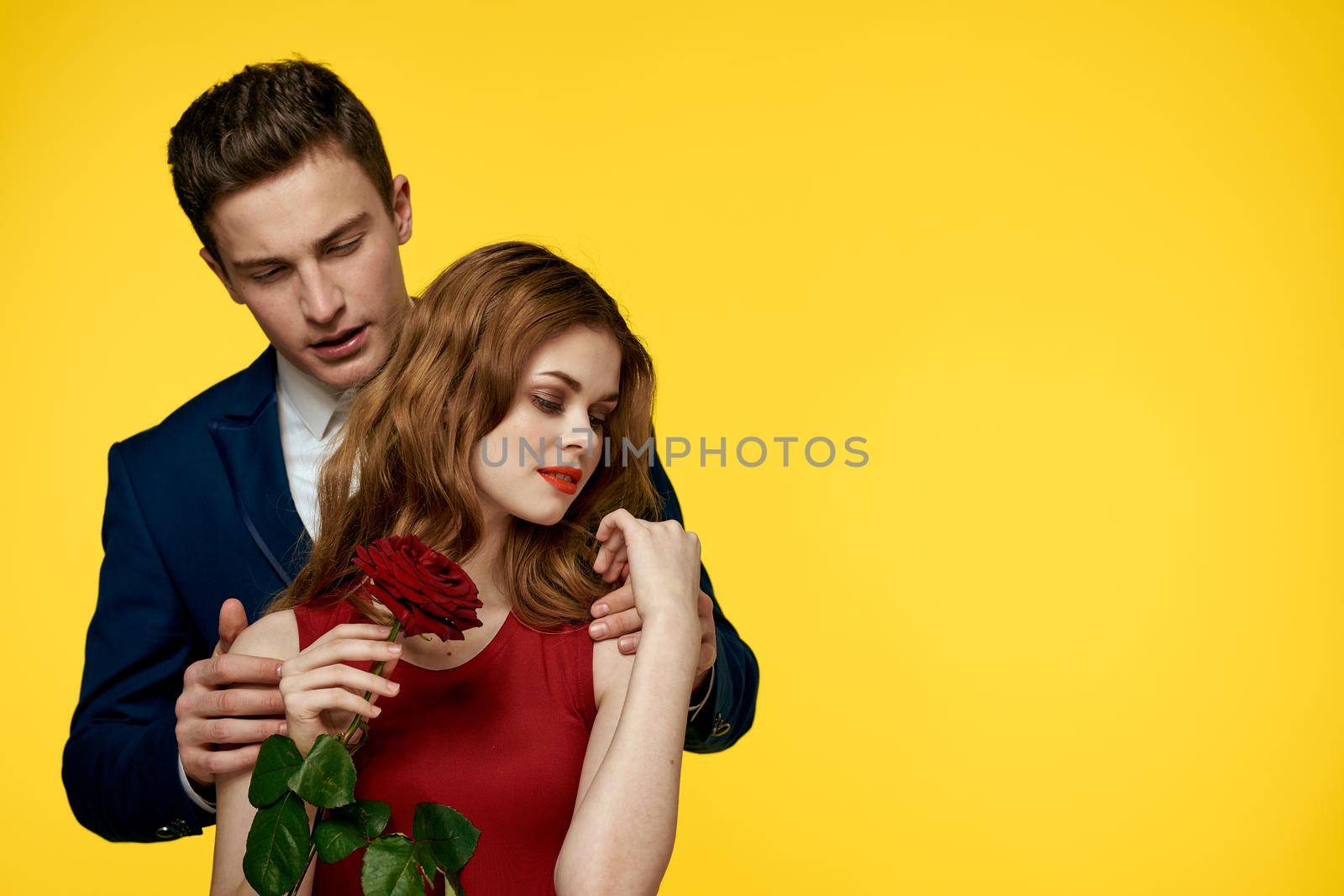 Cute couple dating hug romance yellow background. High quality photo