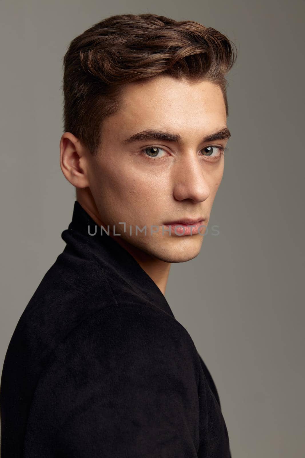 handsome man attractive look fashion hairstyle black shirt close-up. High quality photo