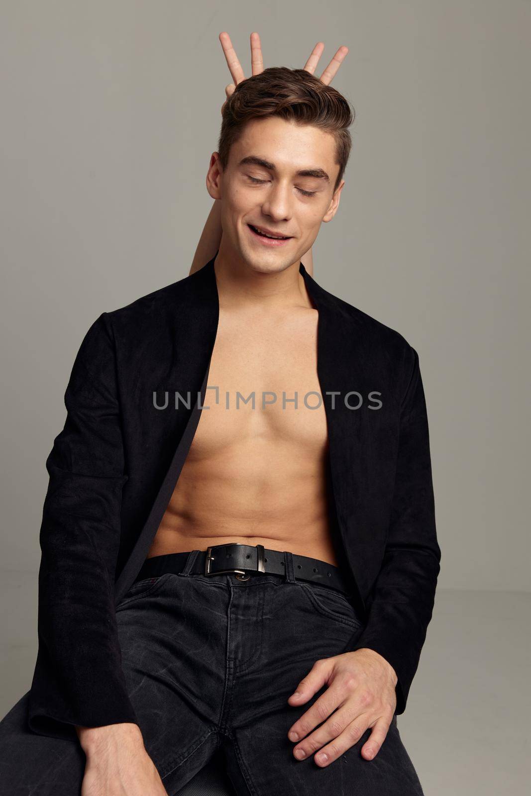 Handsome man naked torso fingers behind his head black shirt romance. High quality photo