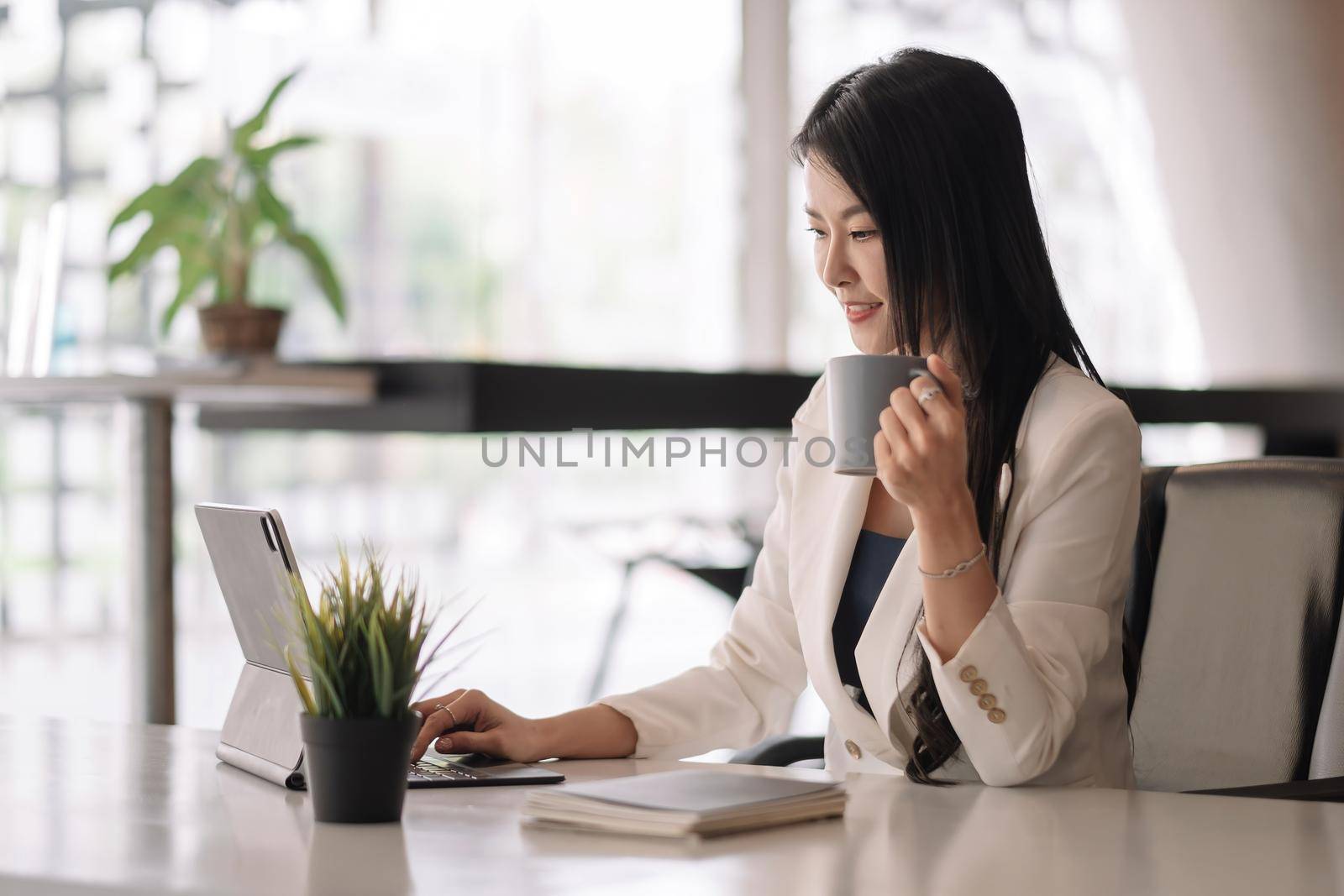Businesswoman using digital tablet on workplace at office.