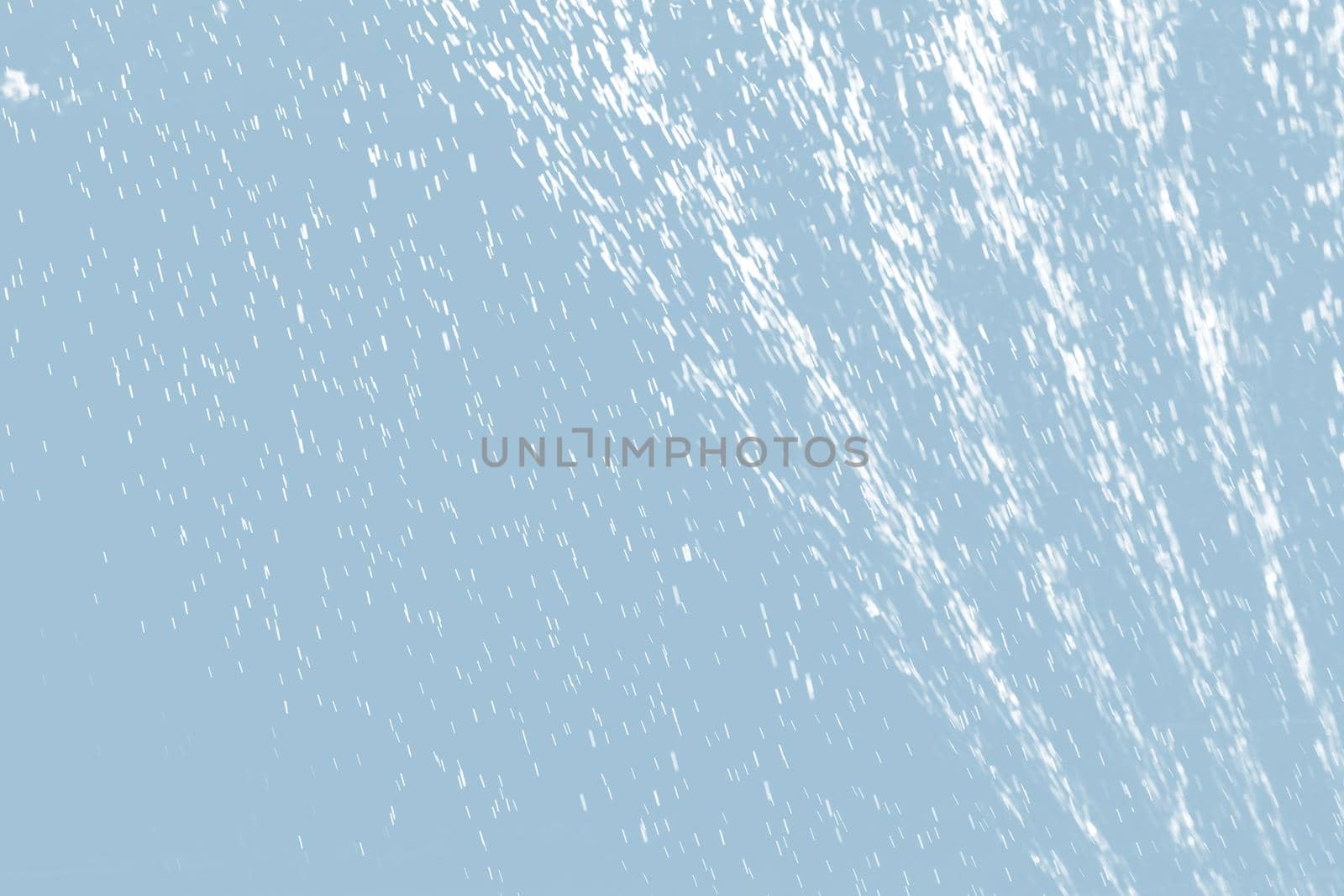 Abstract background of raindrops in light blue tonality