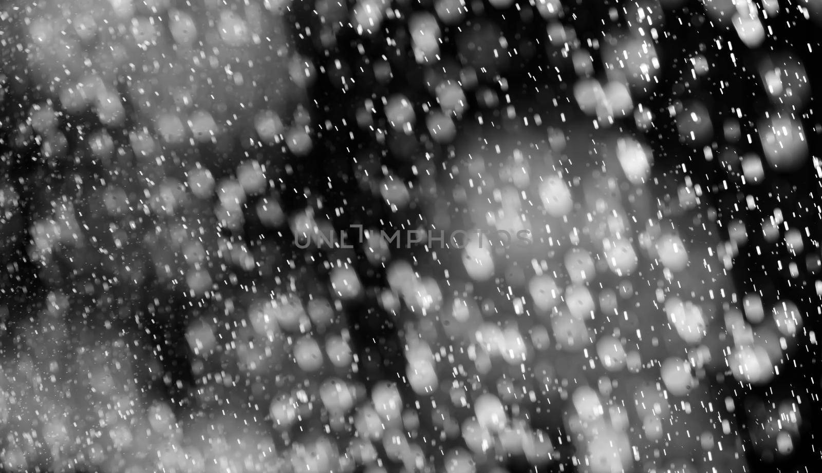 Rain on black. Abstract splashes of water on a black background for screen blending mode and photo retouching.