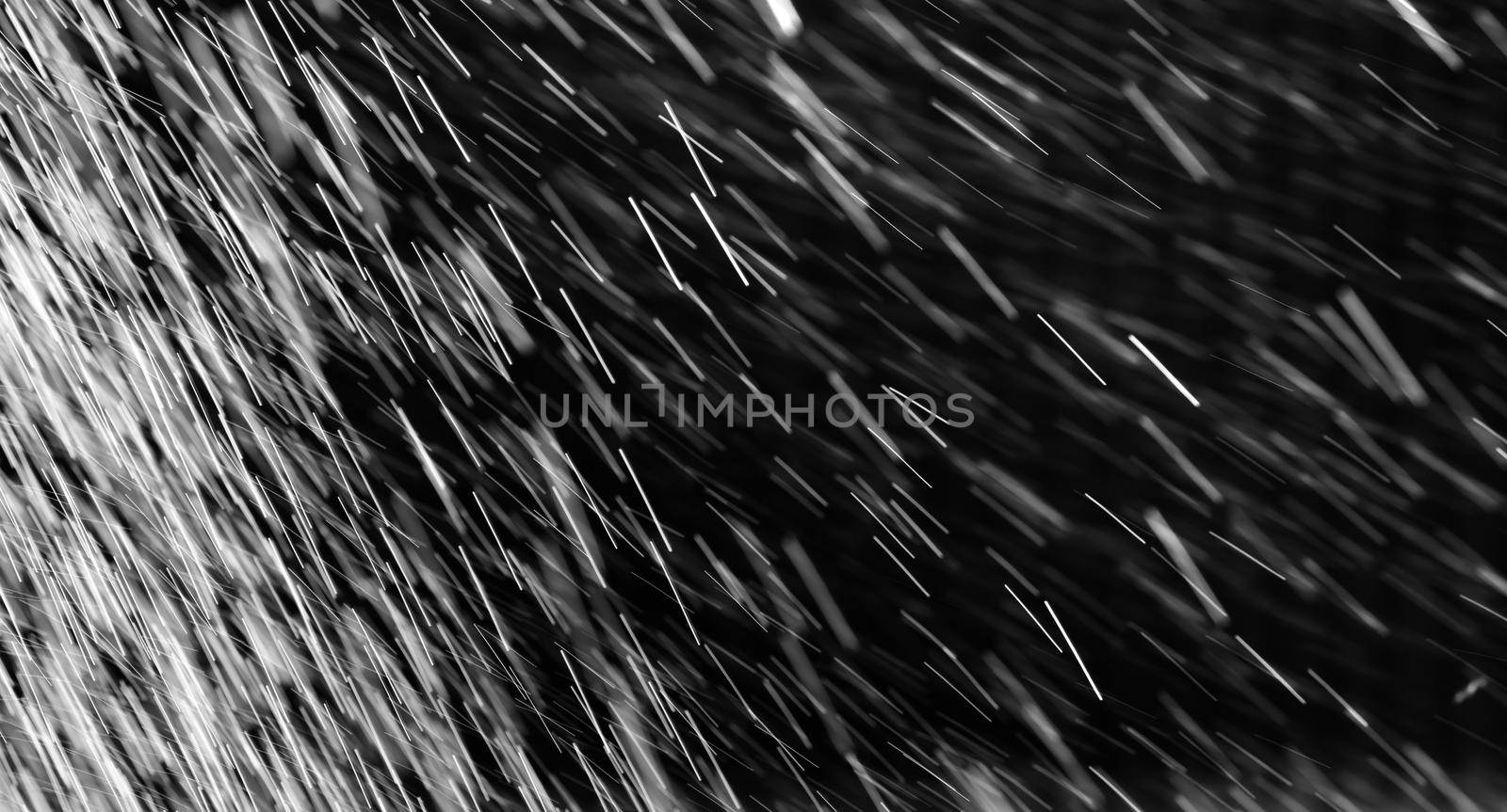 Rain on black. Abstract splashes of water on a black background for screen blending mode and photo retouching.