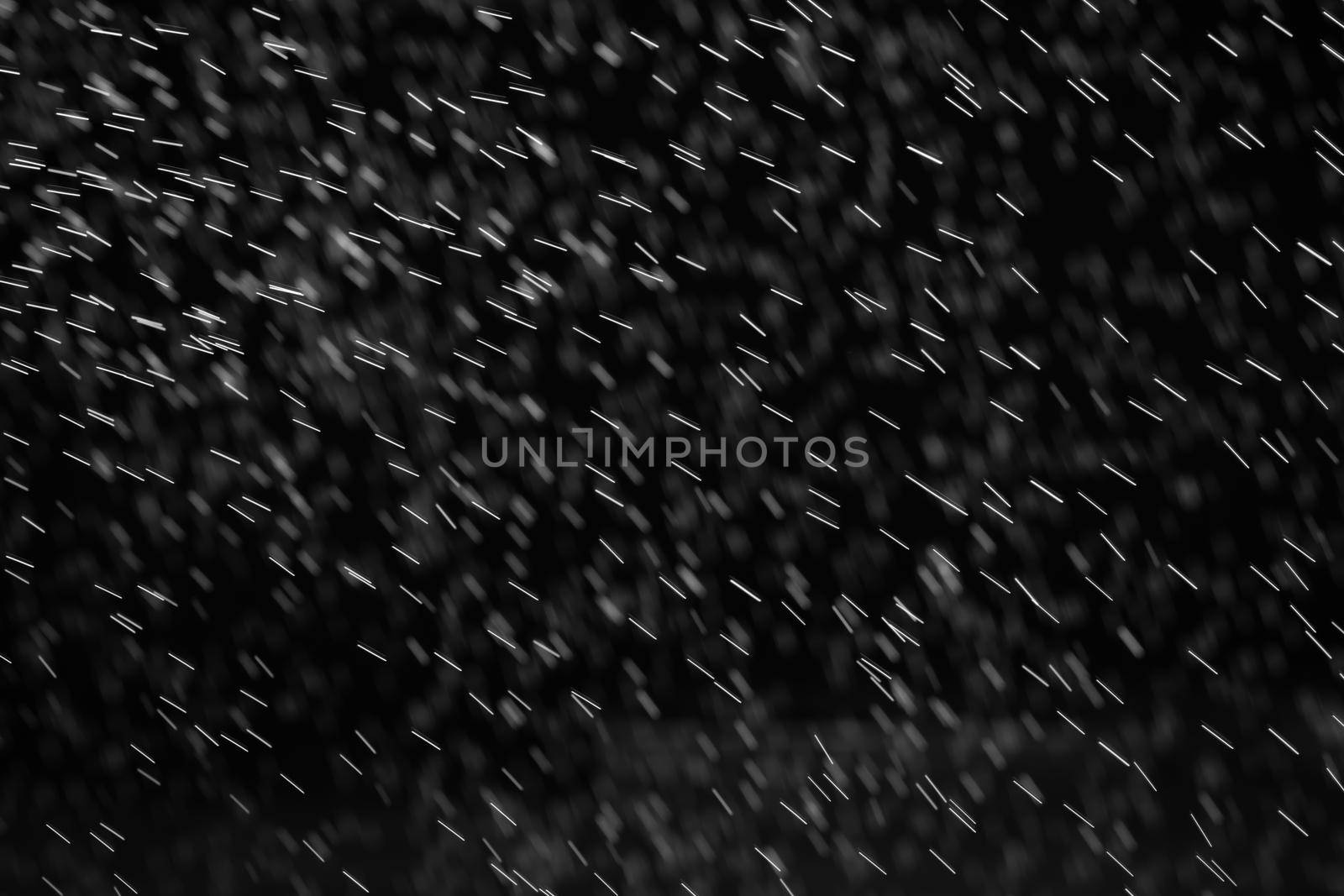 Rain on black. Abstract splashes of water on a black background for screen blending mode and photo retouching.