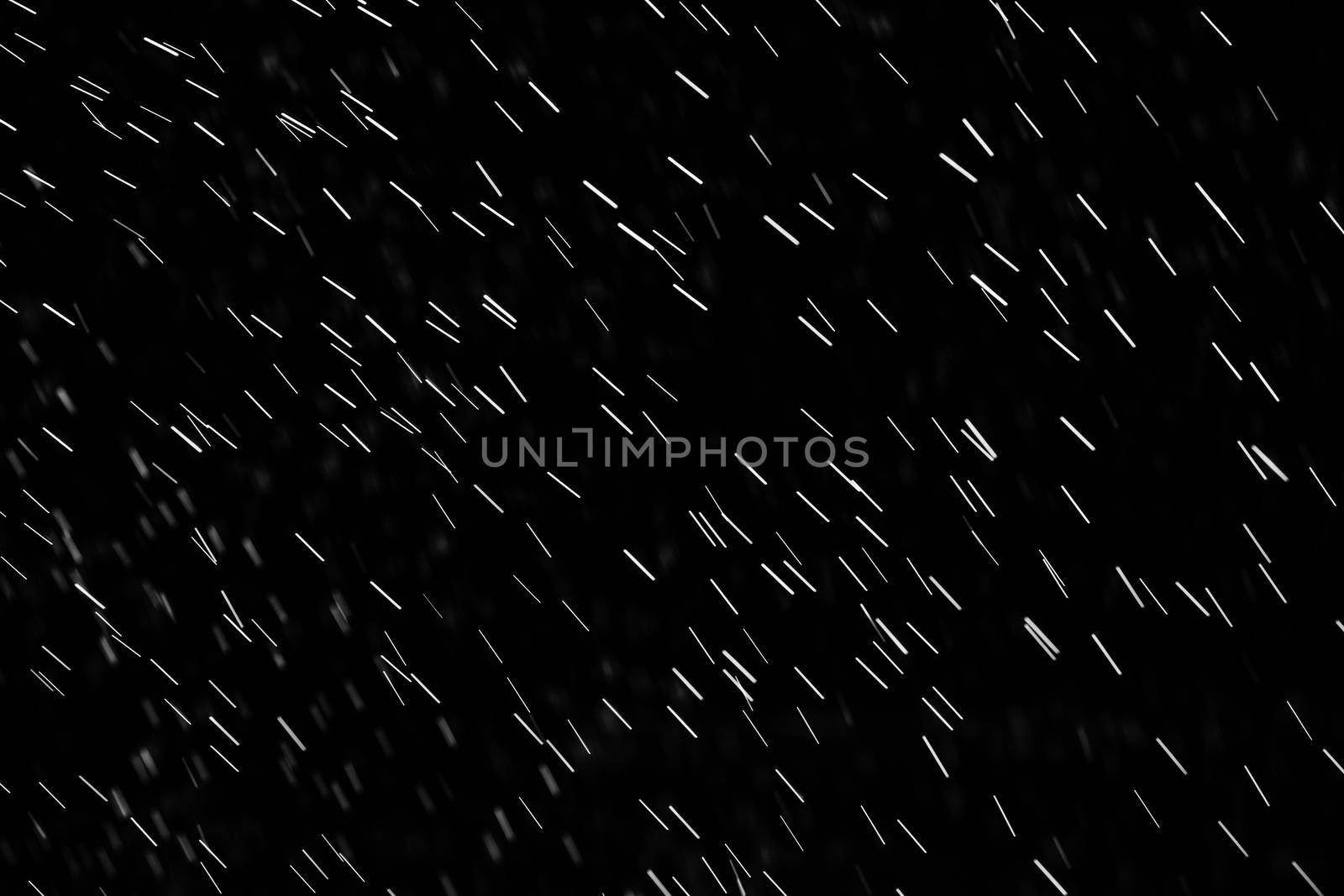 Rain on black. Abstract splashes of water on a black background for screen blending mode and photo retouching.
