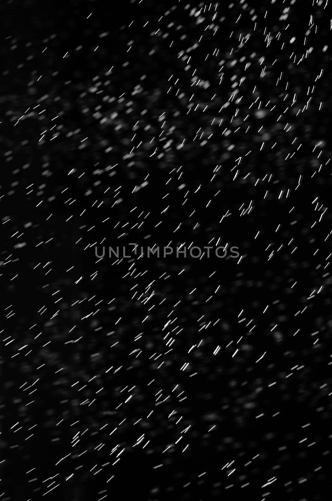 Rain on black. Abstract splashes of water on a black background for screen blending mode and photo retouching.