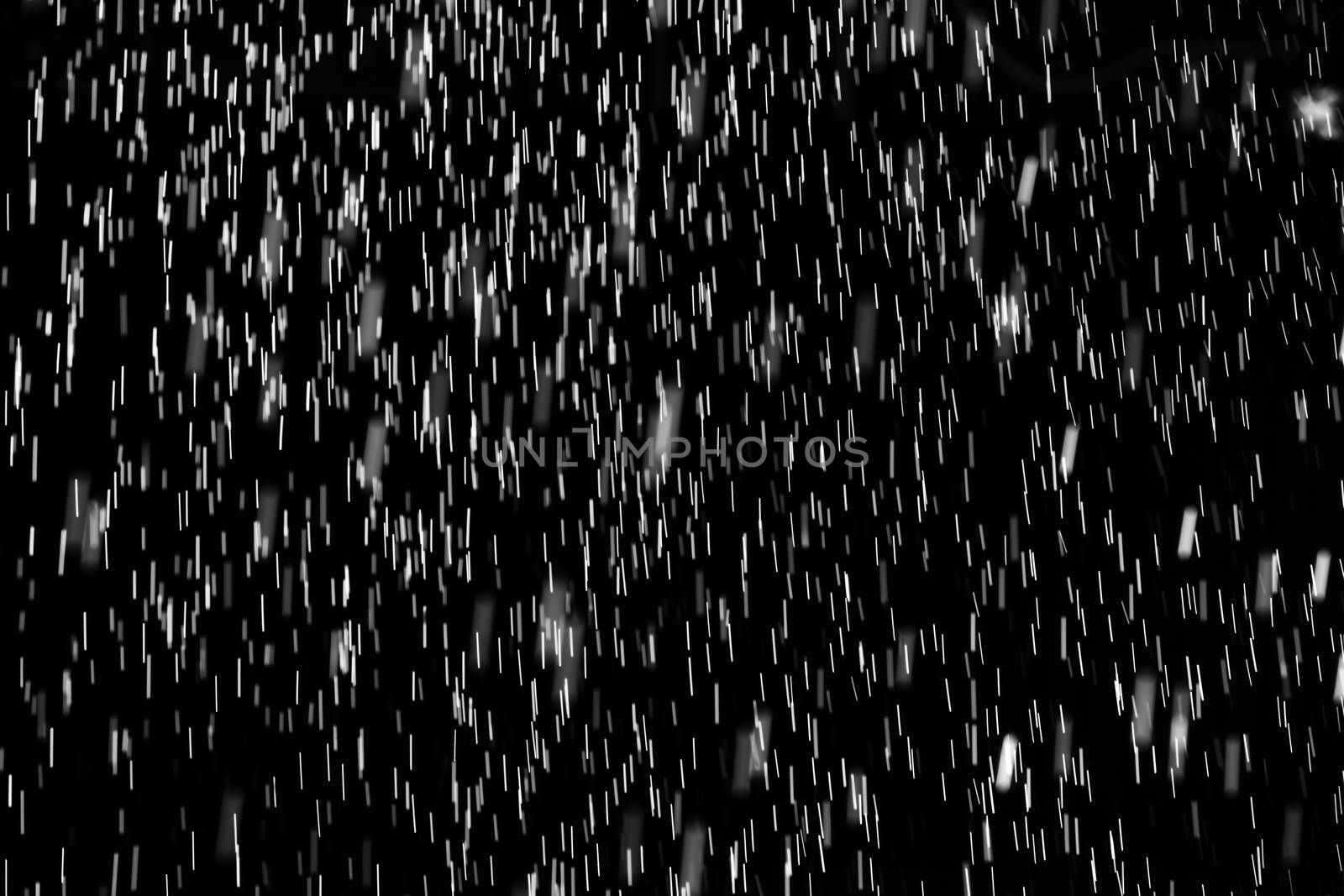 Rain on black. Abstract splashes of water on a black background for screen blending mode and photo retouching.