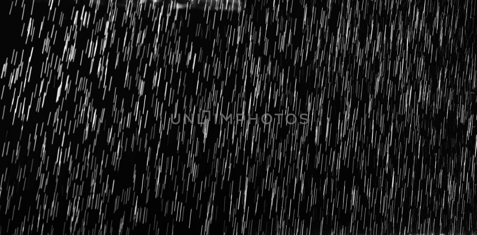 Rain on black. Abstract splashes of water on a black background for screen blending mode and photo retouching.