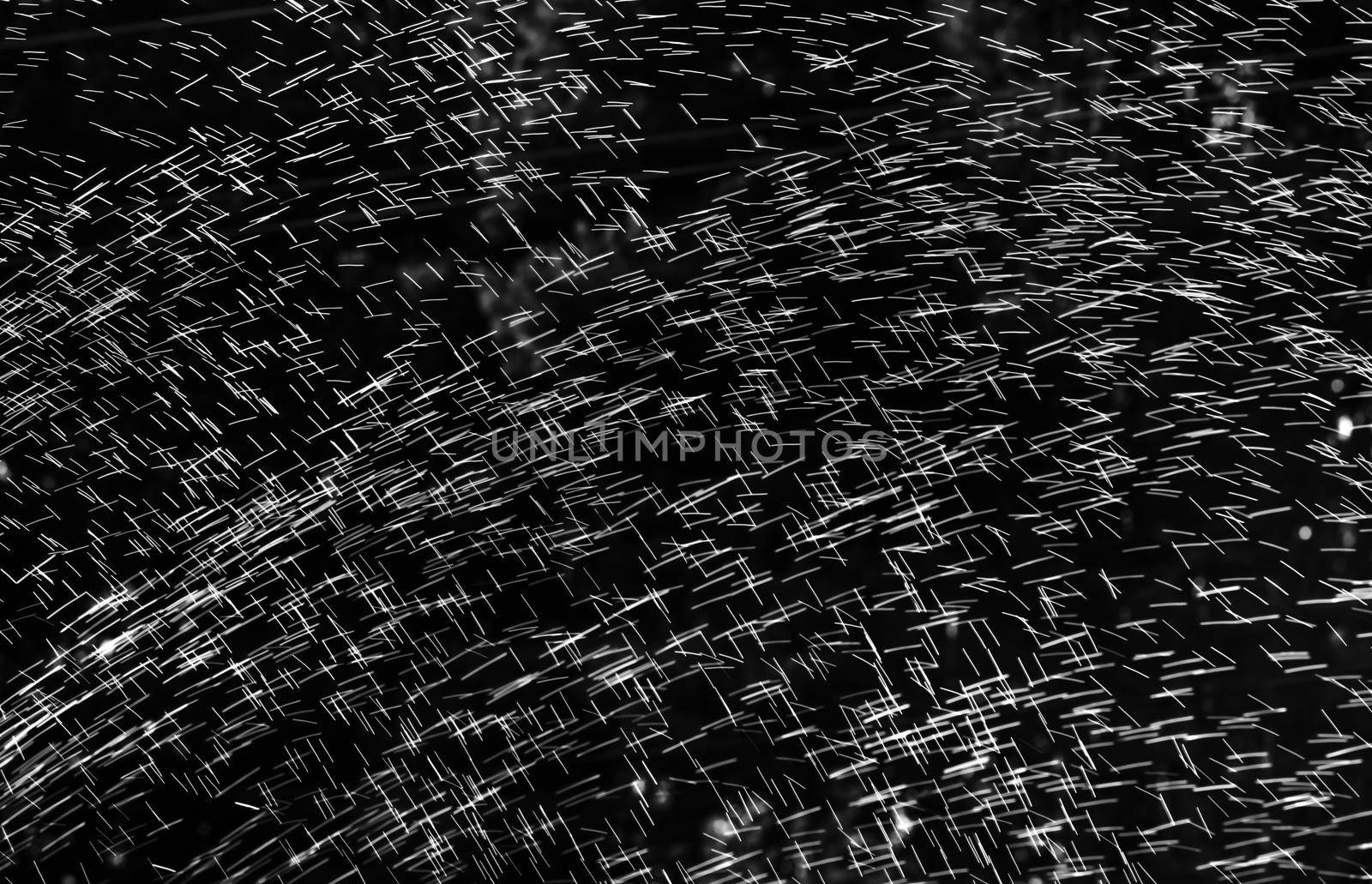 Rain on black. Abstract splashes of water on a black background for screen blending mode and photo retouching.