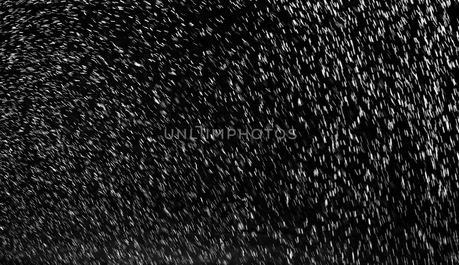 Rain on black. Abstract splashes of water on a black background for screen blending mode and photo retouching.