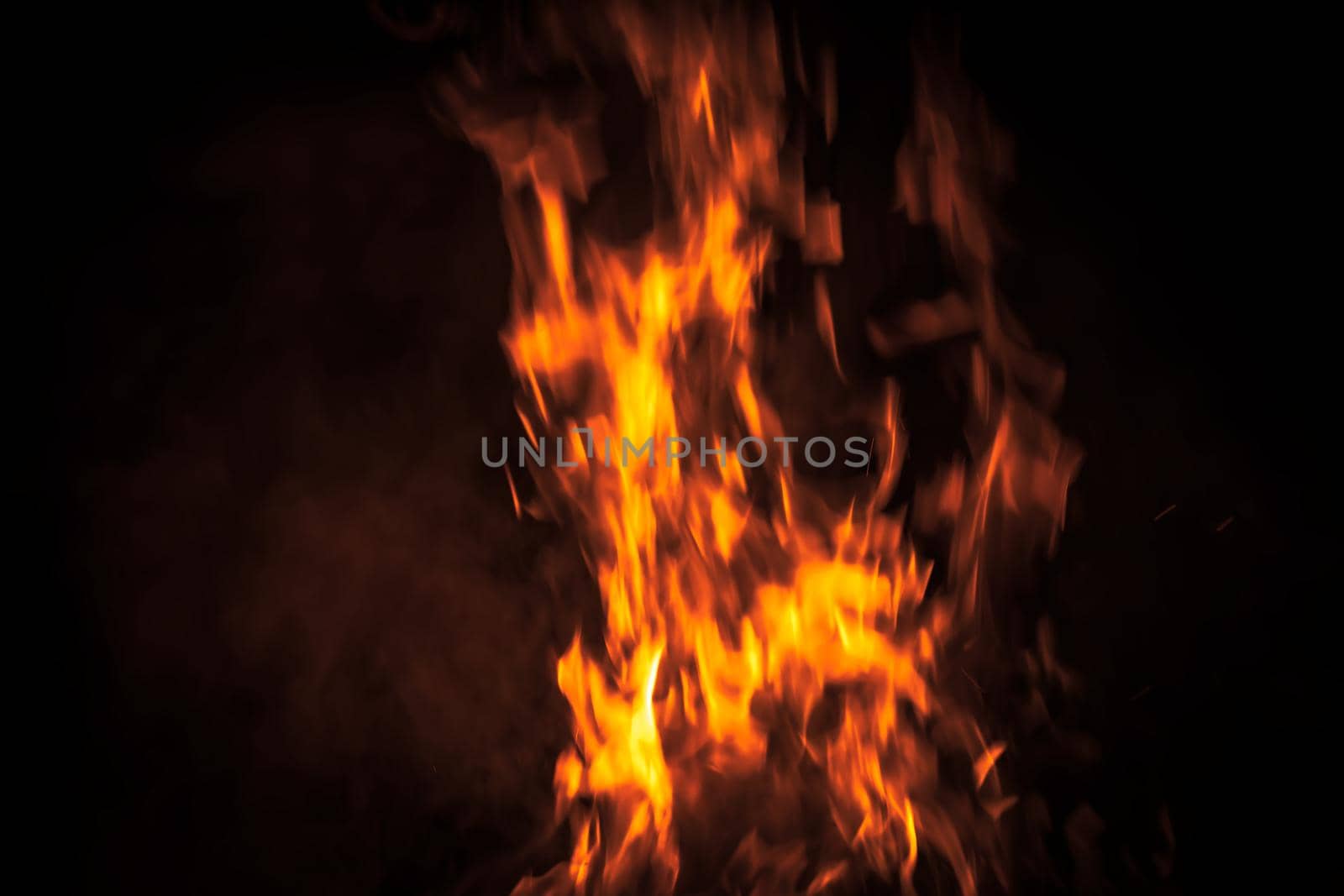 Flames of bonfire at night. Fire flames on a black background