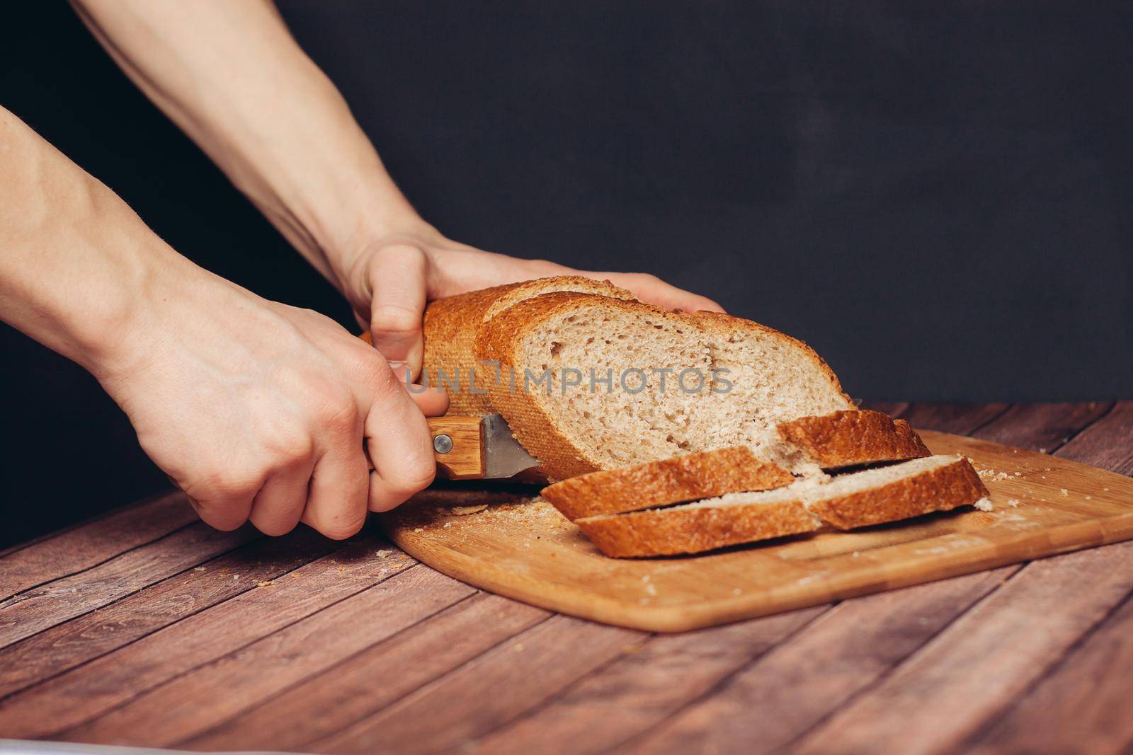 slicing loaf on a cutting board wooden table kitchen food flour product. High quality photo