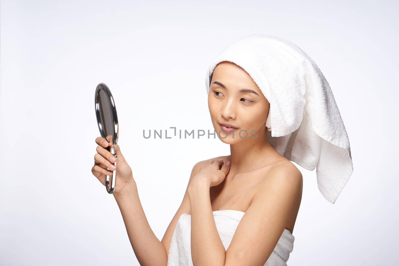pretty woman looking in the mirror clean skin after shower. High quality photo
