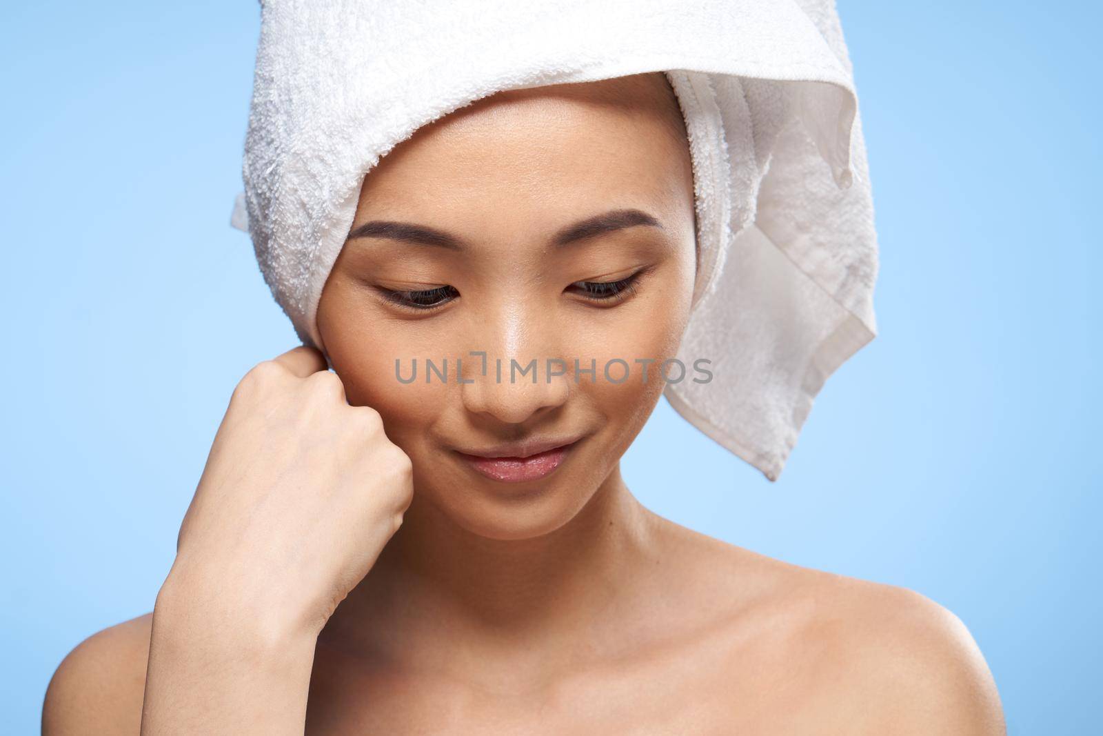 asian woman naked shoulders towel on head spa treatments close-up. High quality photo