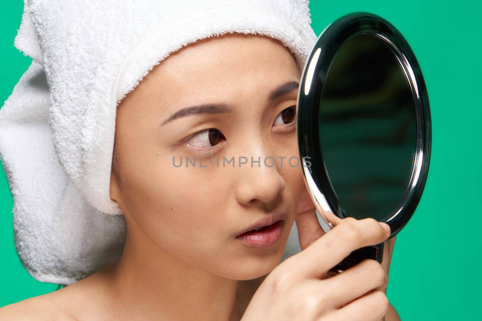 pretty woman from clean skin mirror in hands care care. High quality photo