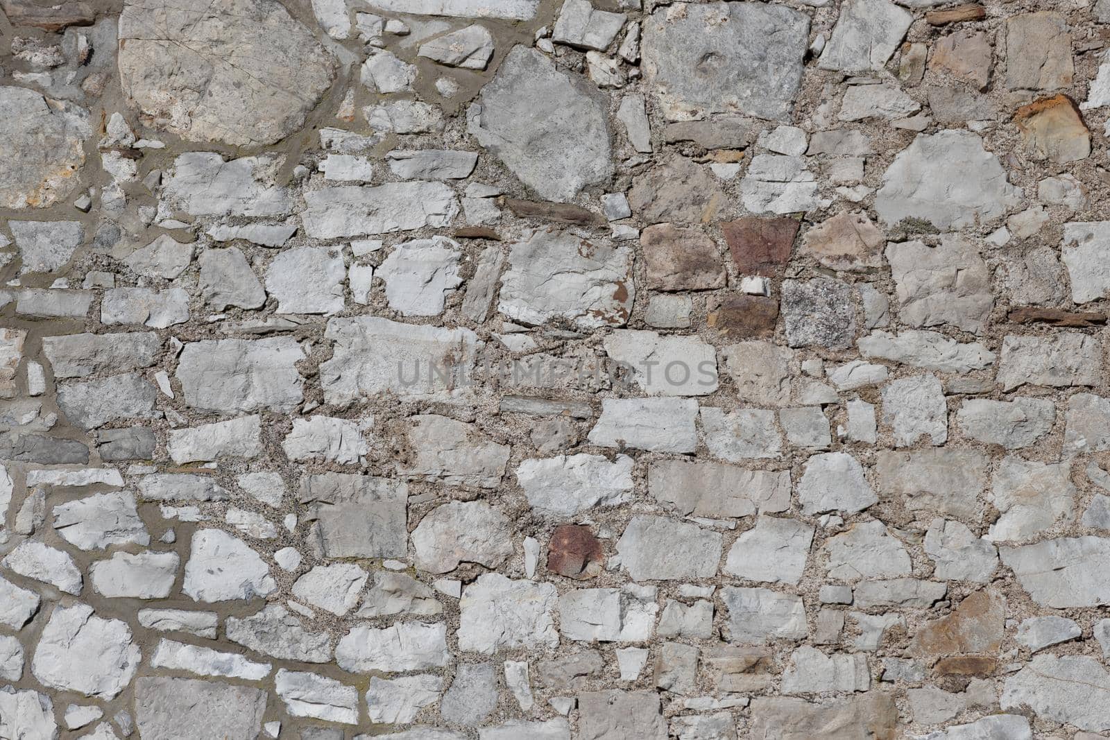 Grey stone wall from an historic castle as texture and background by reinerc