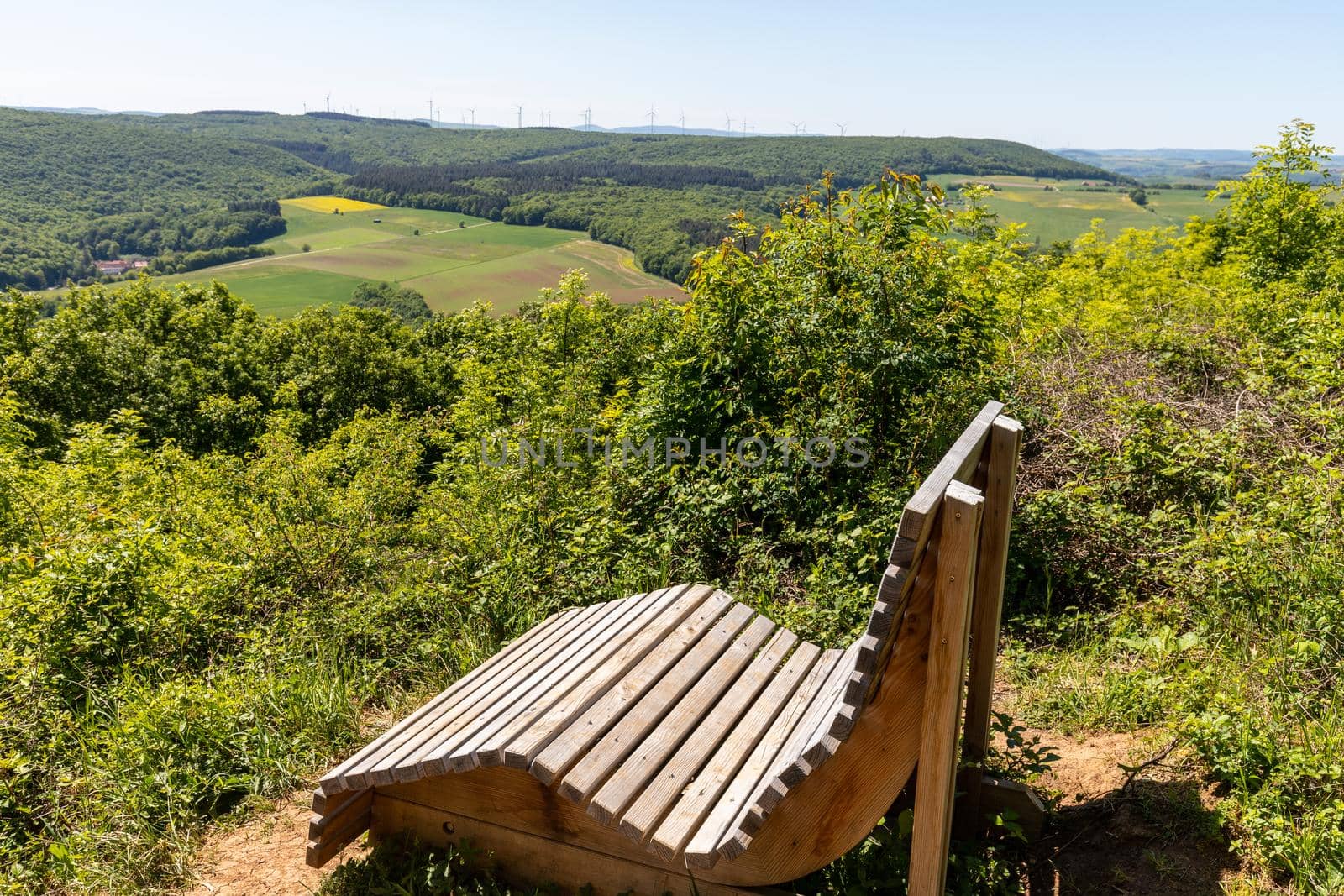 Scenic view from the Lemberg at landscape with  wooden relaxing bench in the foreground