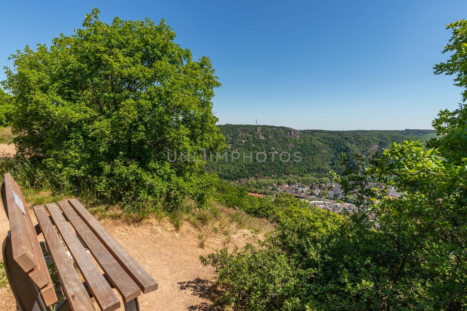 High angle view from the Rotenfels of Bad Muenster am Stein Ebernburg with wooden bench in the foreground