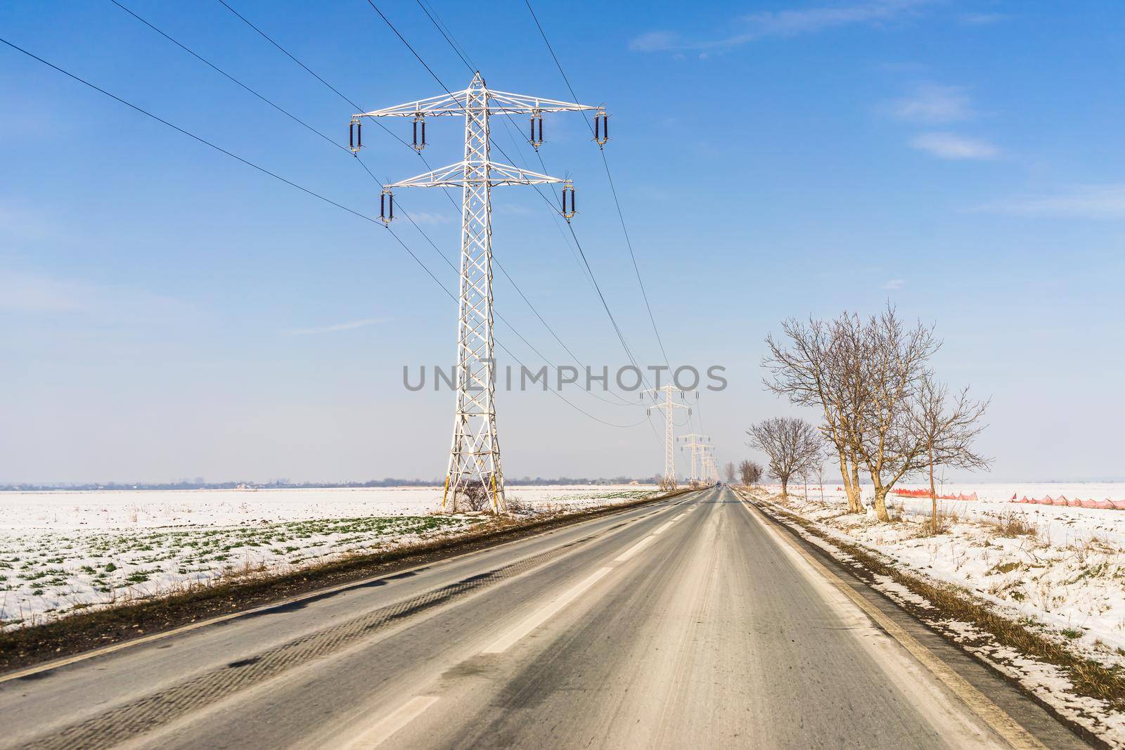 Winter season, view of cars and snowy street through windshield while driving in Bucharest, Romania, 2021.   by vladispas