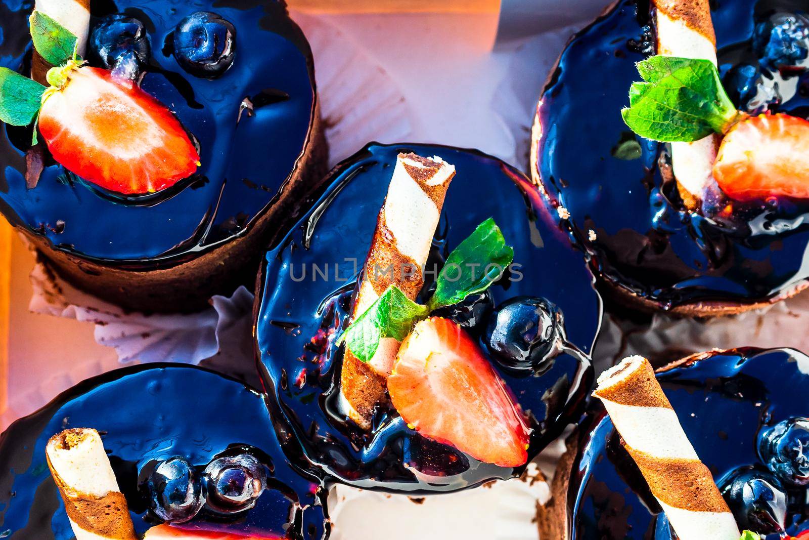 Chocolate mousse cakes decorated with strawberry and chocolate stick. by vladispas