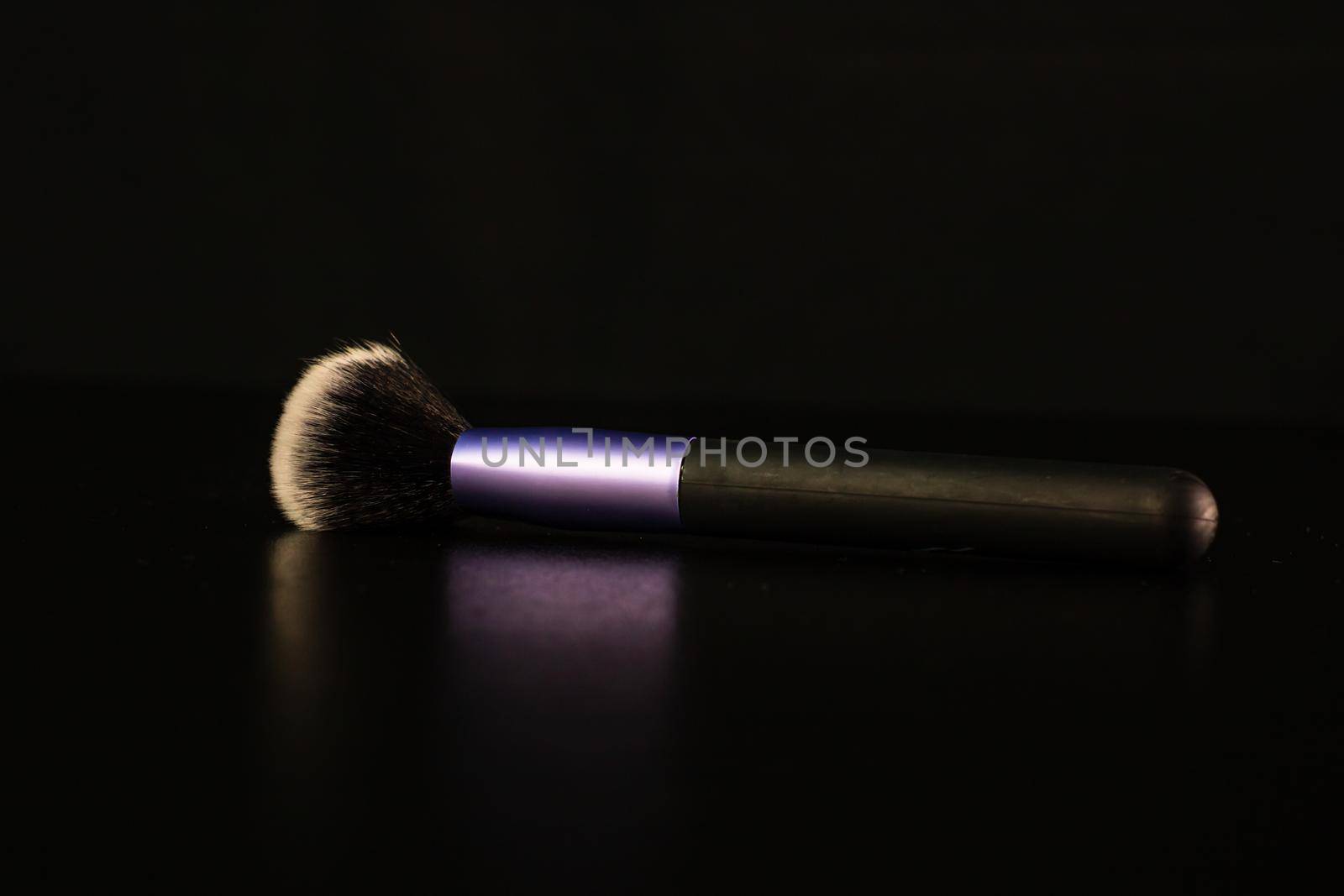 Cosmetic concept, make up brush isolated on black background.