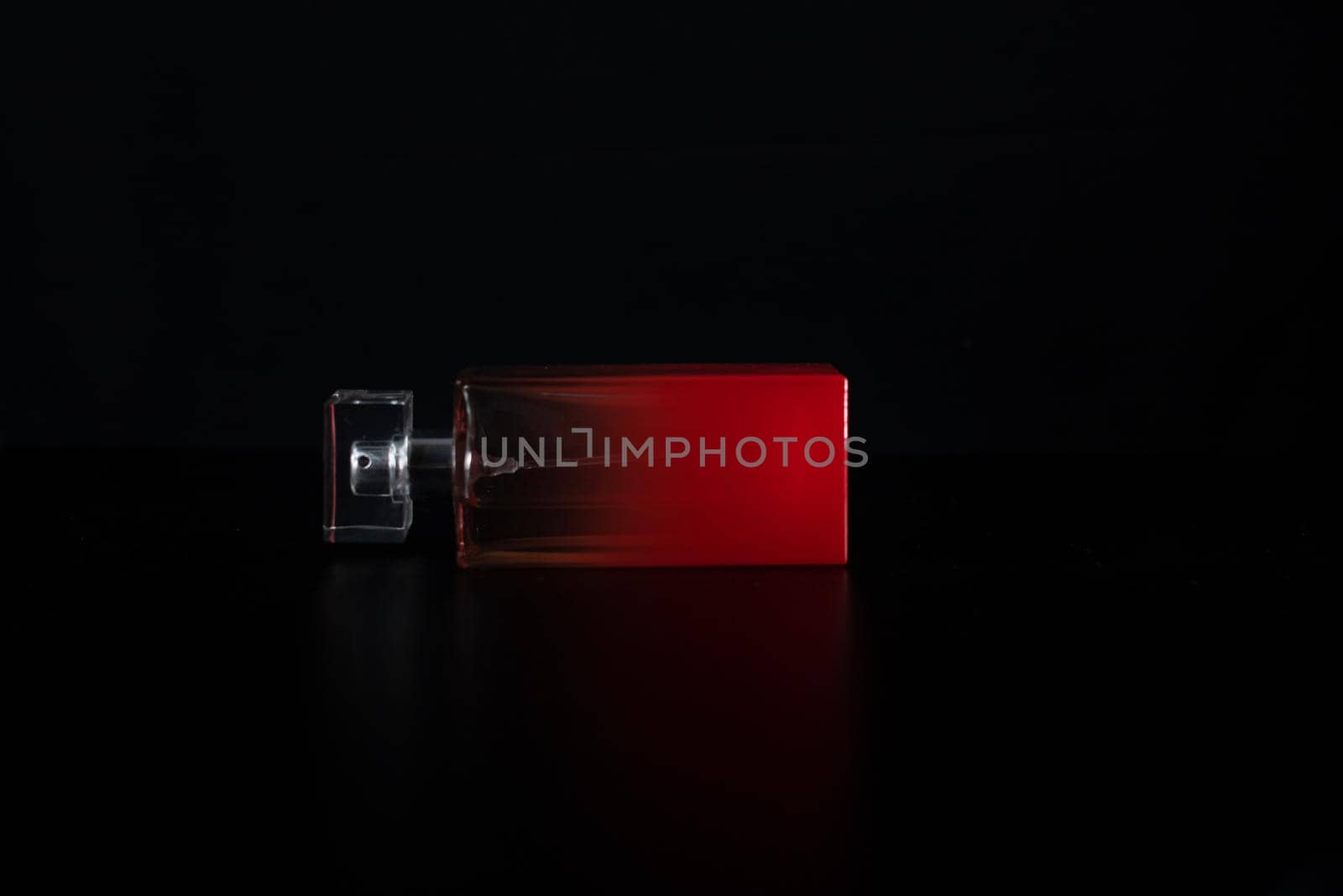 Elegant perfume bottle isolated on black background with copy space.