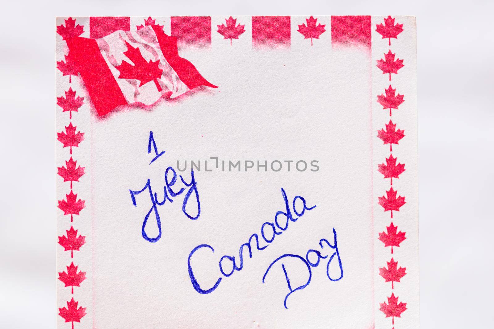 Canada day 1 July handwriting on paper with Canada flag. Writing text on memo post reminder