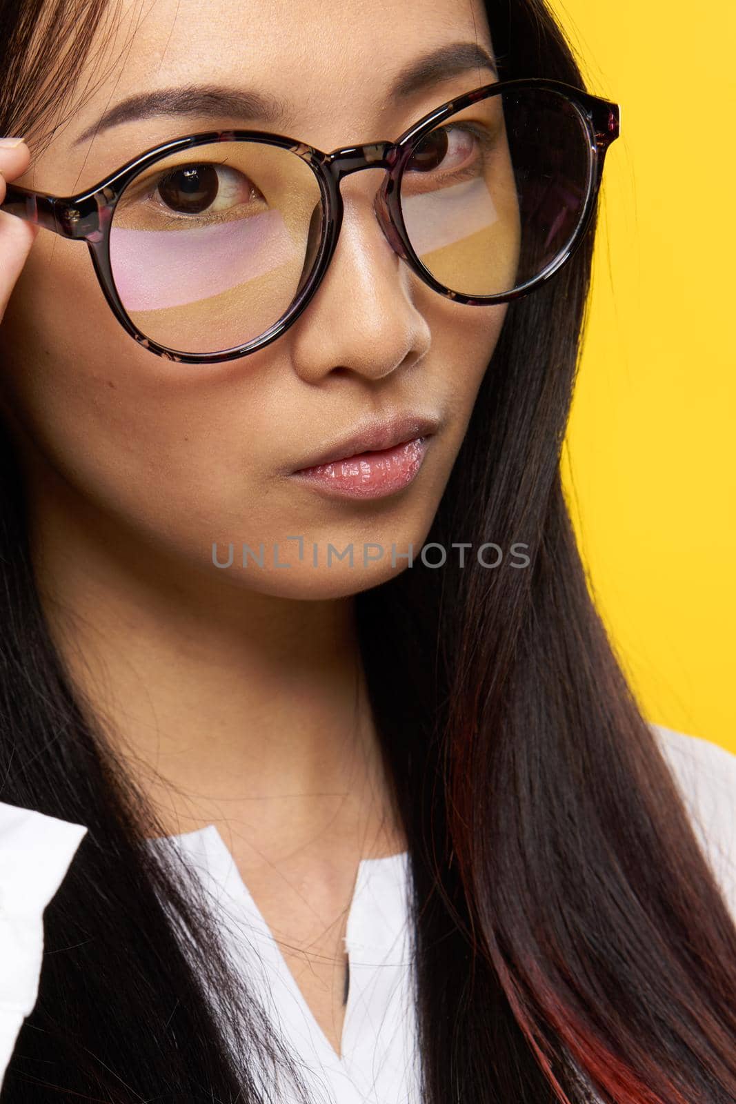 elegant woman of asian appearance with glasses close-up attractive look. High quality photo