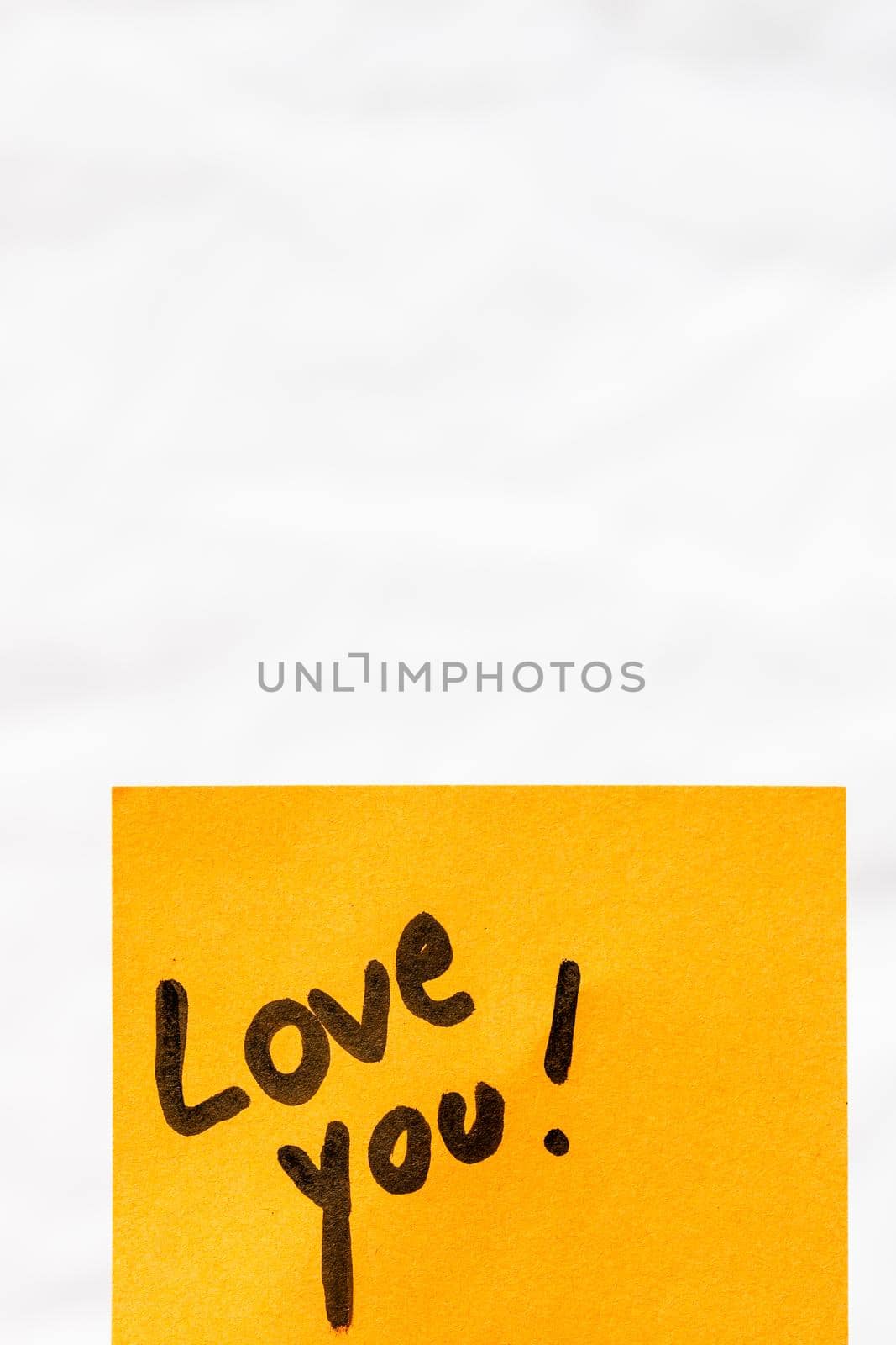 Love you handwriting text close up isolated on orange paper with copy space.