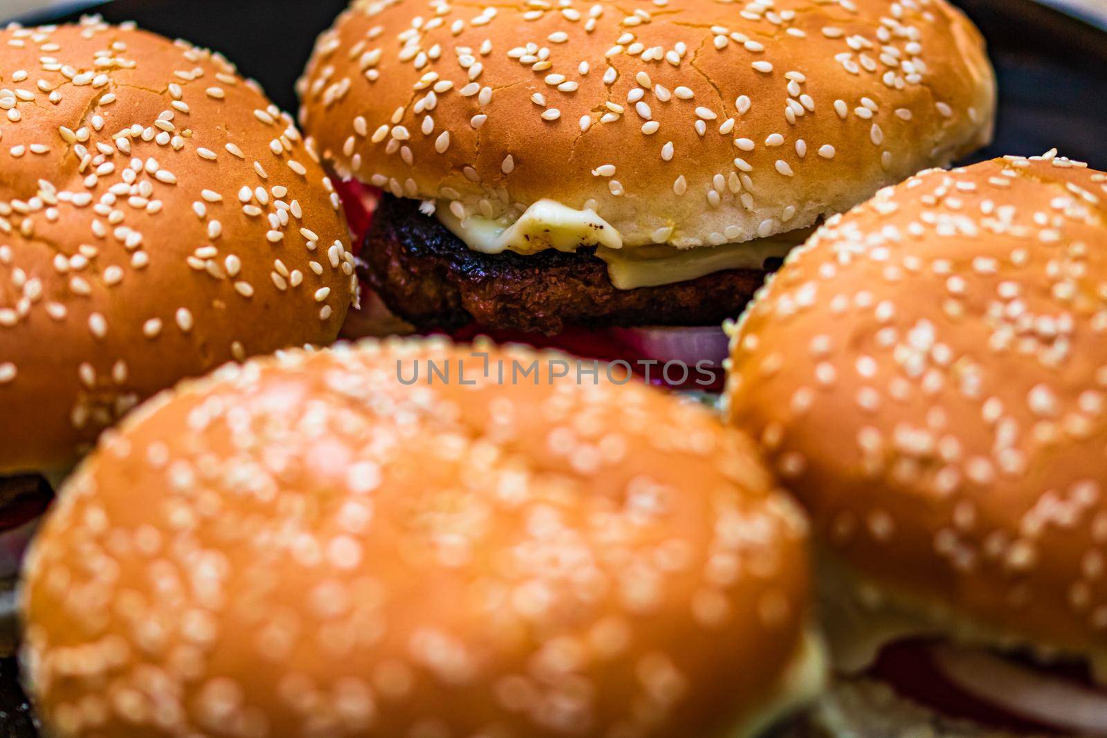 Closeup of fresh homemade tasty burgers on wooden table