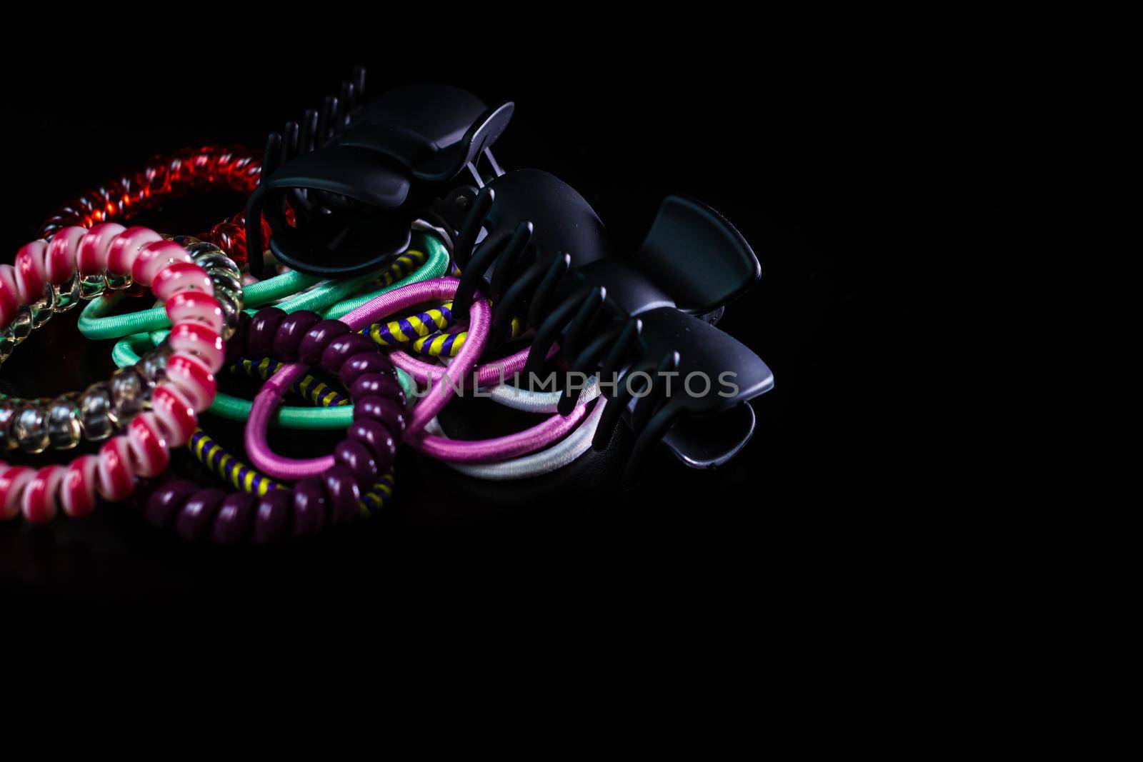 Hair accessories, colorful hair scrunchies isolated on black background. by vladispas