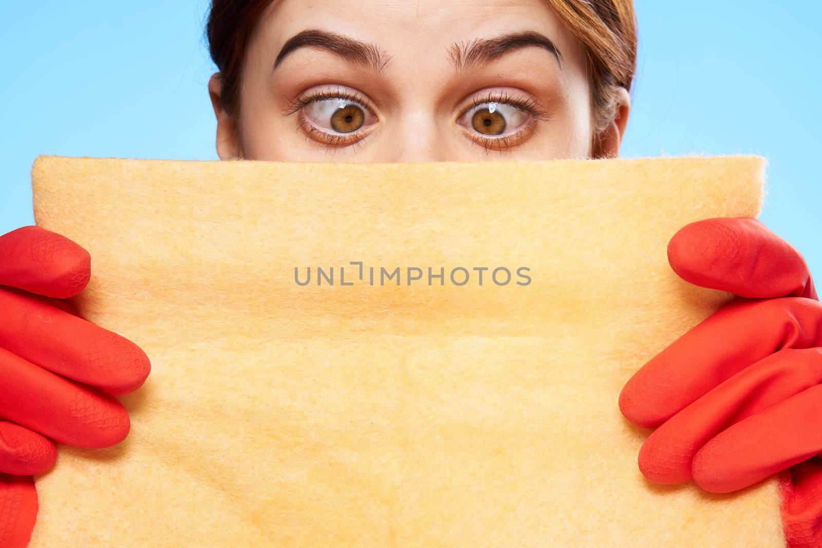 cleaning lady in rubber gloves holding a rag in her hands closeup emotion. High quality photo