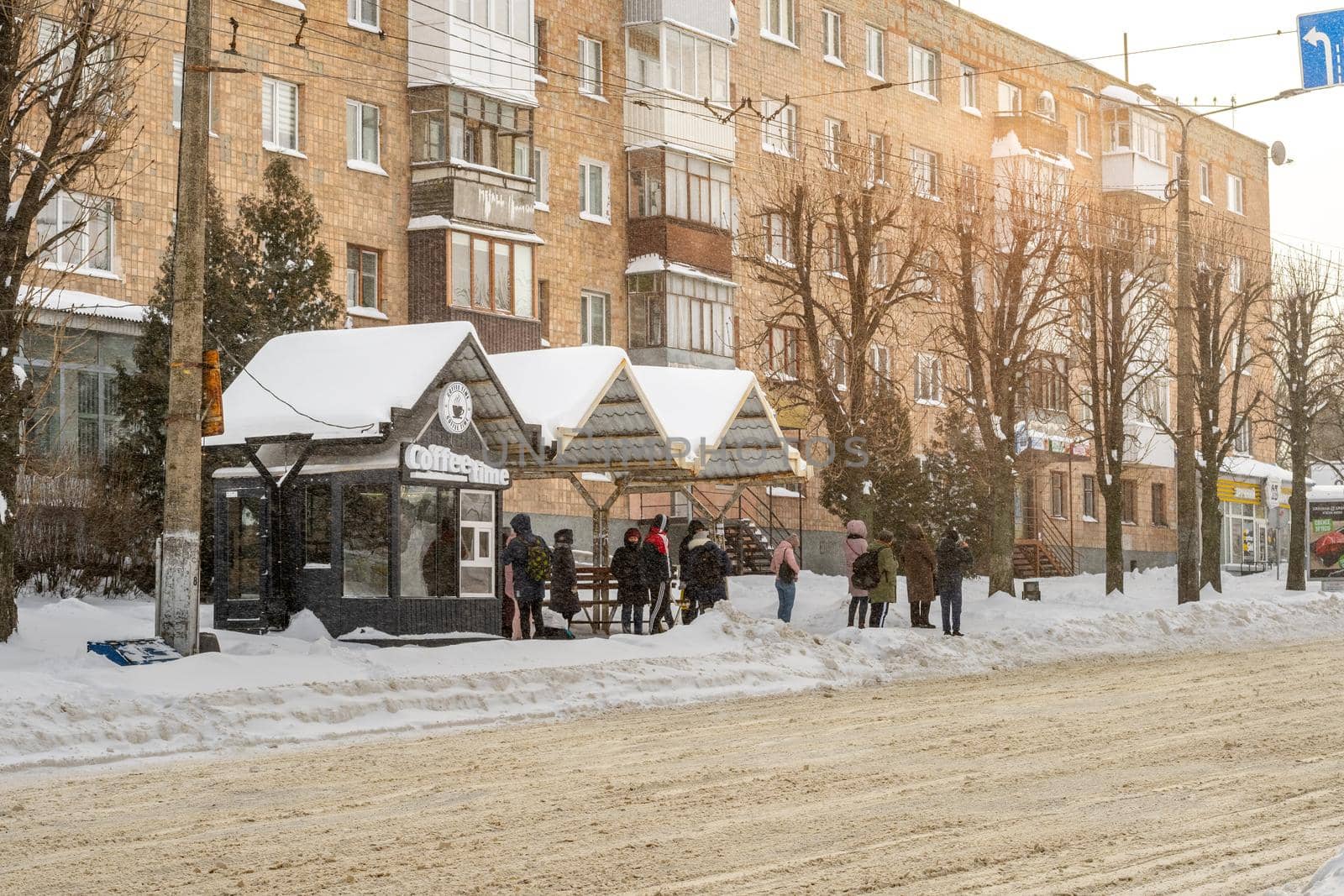 Lutsk, Ukraine - February 12,2020: People on street after snow storm. City street after blizzard. Record-breaking amounts of snow. Uncleaned slippery roads and sidewalk in winter. Cars in snowdrift