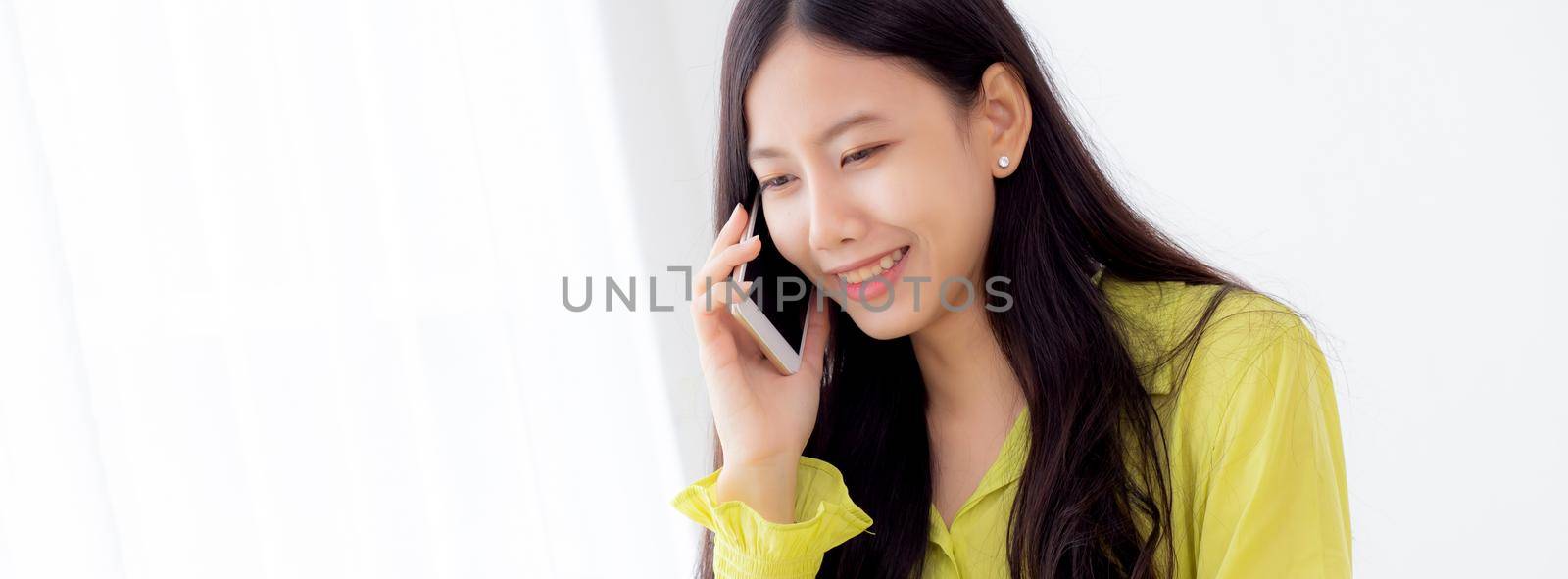 Young asian business woman working form home office and call phone for success at home, businesswoman using laptop computer on desk, female talking smartphone at workplace, communication concept.