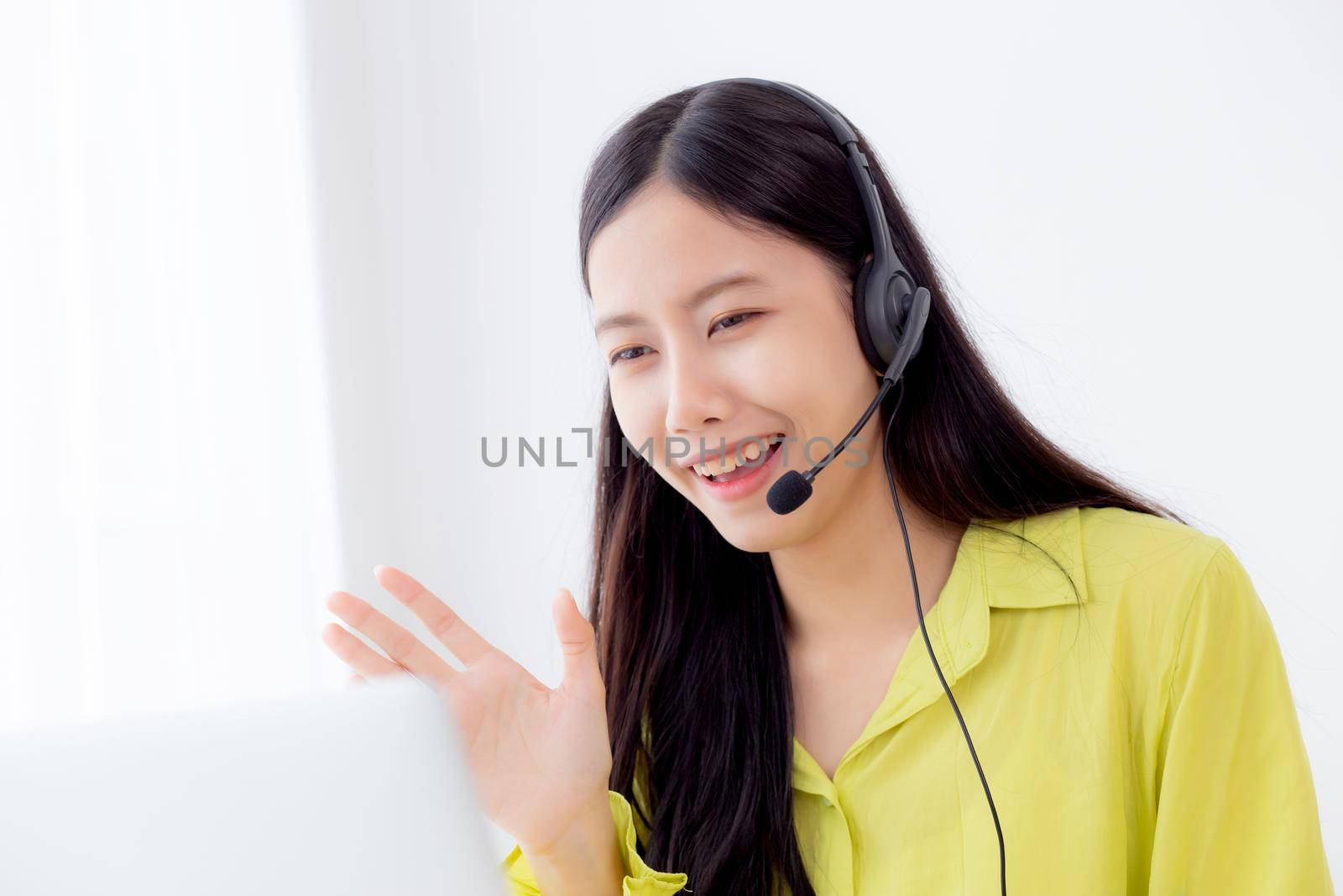 Young asian business woman using laptop computer for video conference online with social distancing, businesswoman working with video call, new normal, communication and work from home concept.