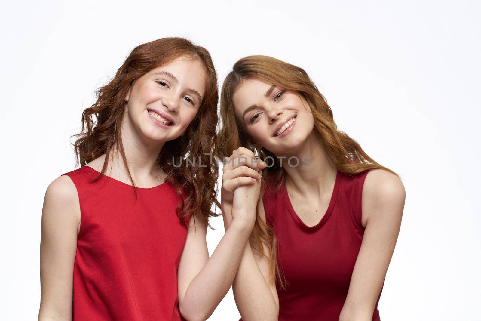 Mom and daughter red dress hug family joy friendship. High quality photo