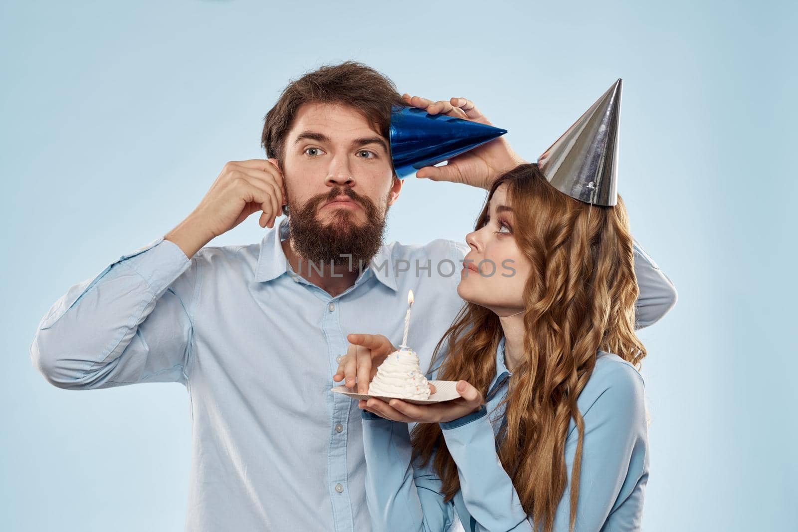 Birthday corporate young man and woman with cake on isolated background disco party. High quality photo