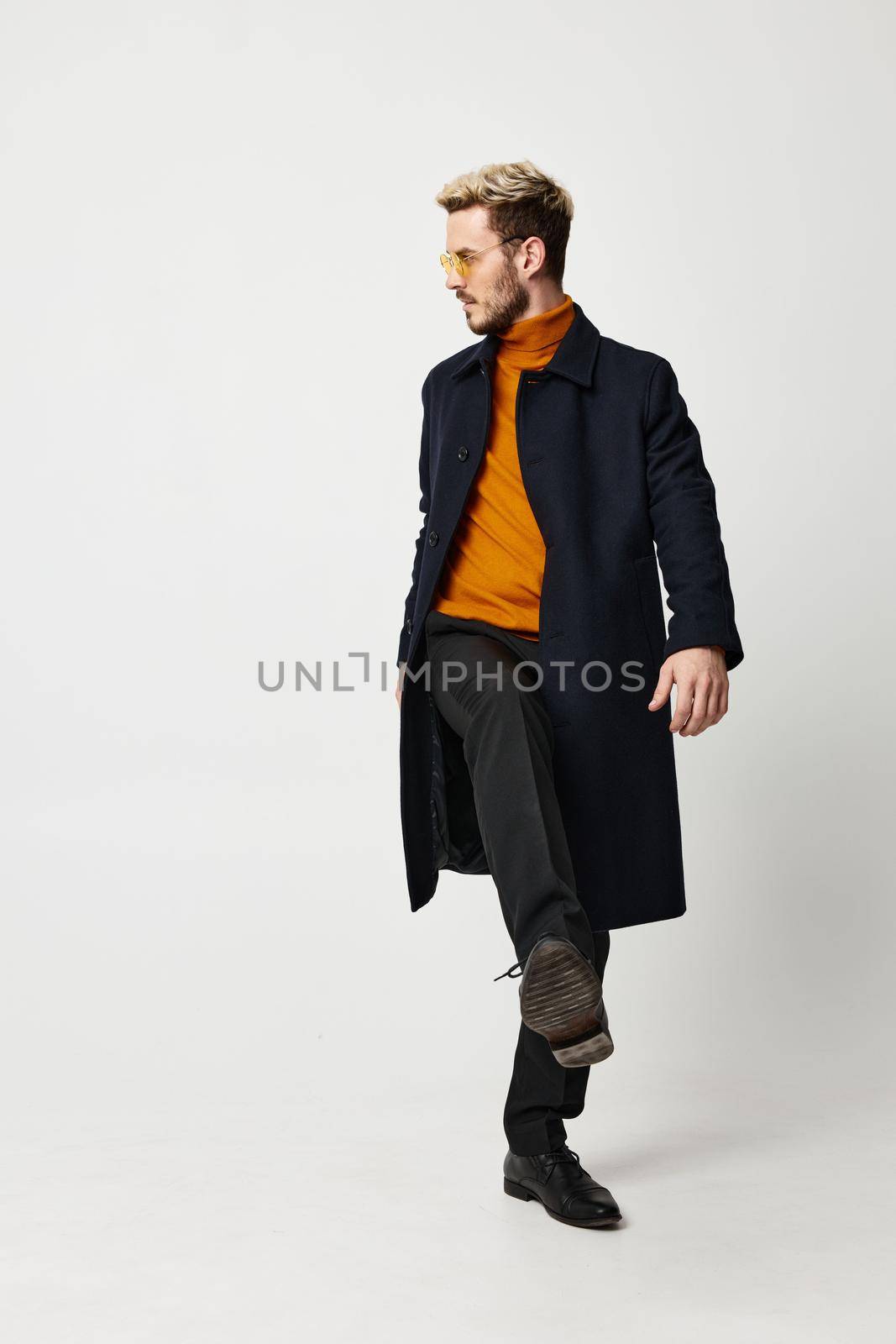 energetic man in orange sweater modern adult man suit coat pant. High quality photo