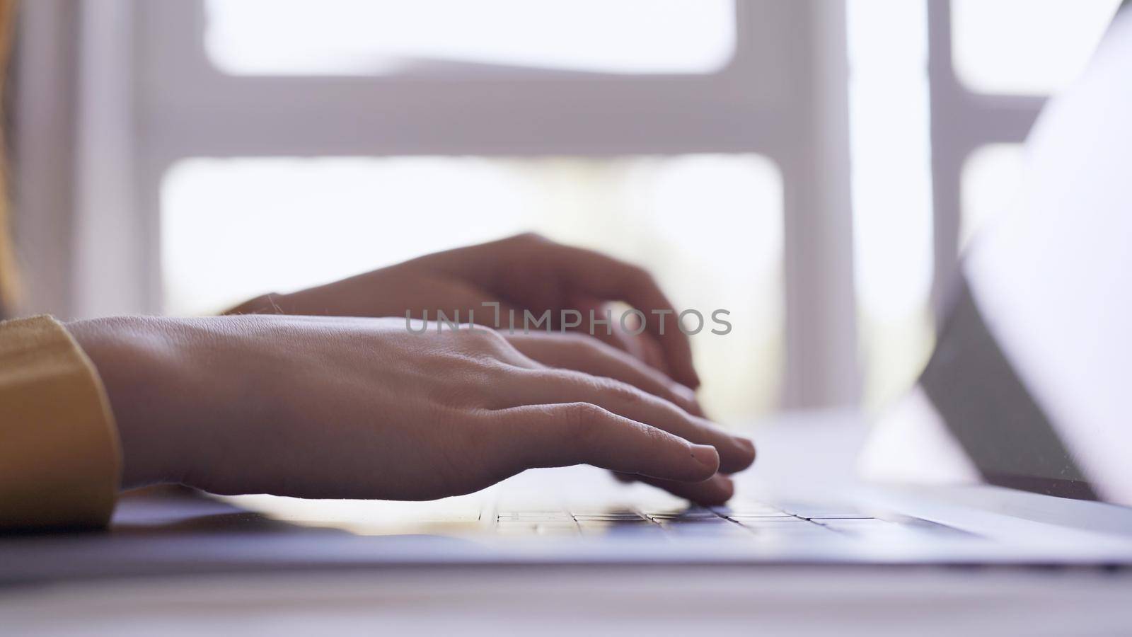 female hands are typing text on laptop work is internet close-up. High quality photo