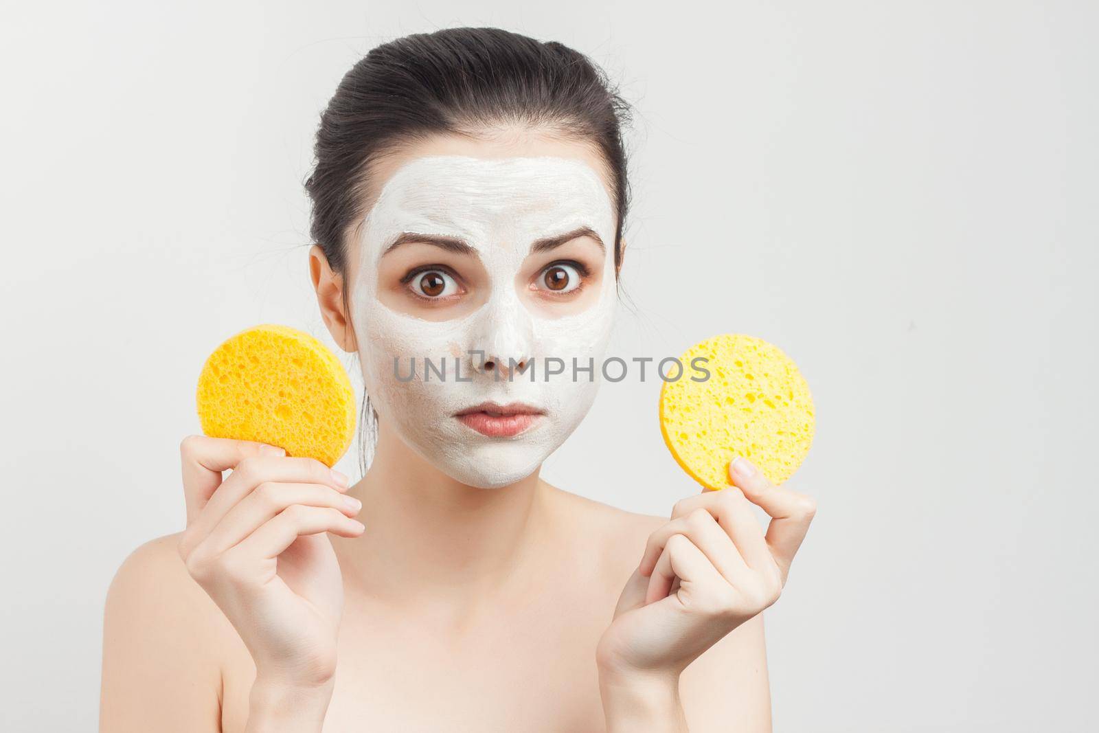 cheerful woman holding sponges in hands removing makeup scrub. High quality photo