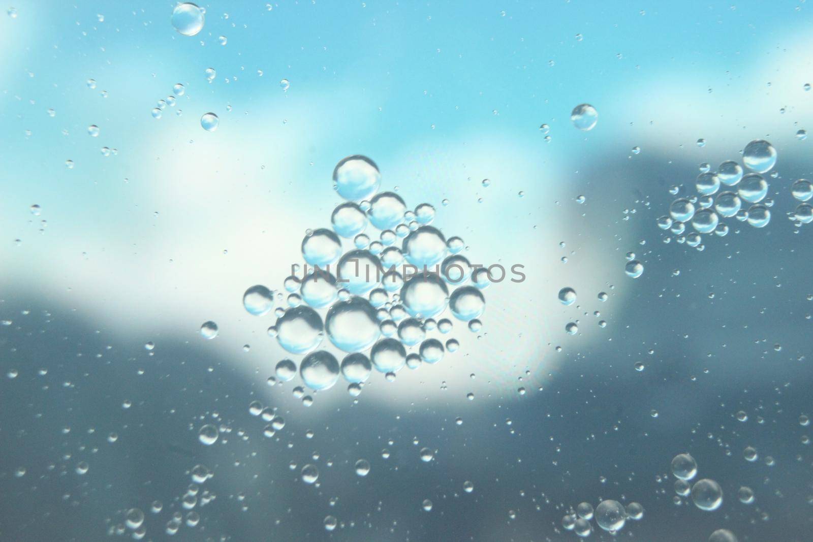 abstract macro background of oil circles floating over water surface . Macro closeup view of bubbles on water . oil bubbles in the water macro photographic background