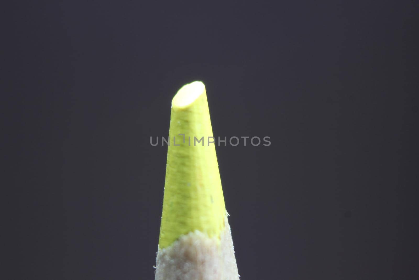 close up of sharpened pencil.Macro view of the tip of the pencil on a black background.