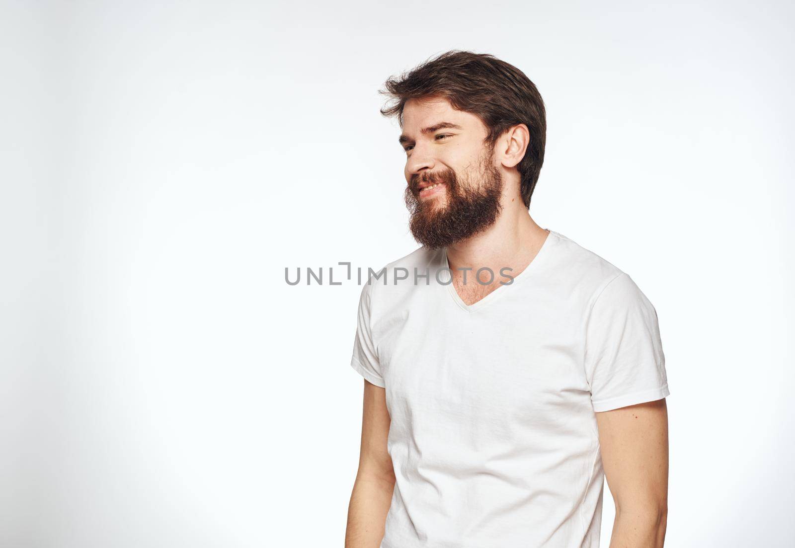 energetic man with beard on white background gesturing with hands cropped view. High quality photo