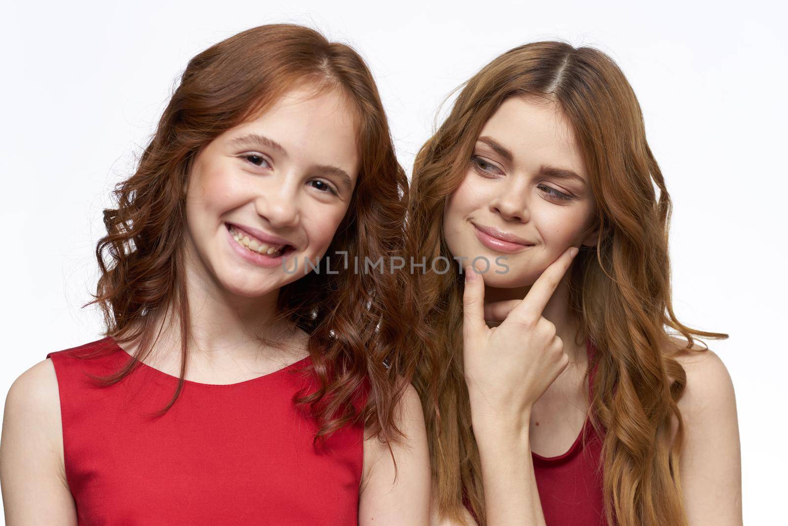 Cheerful mom and daughter hugs joy lifestyle family light background. High quality photo