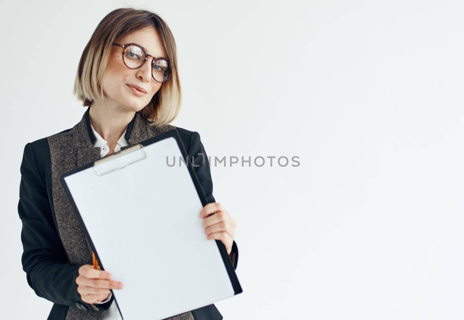 Business woman in a jacket manager model glasses and a white sheet of paper. High quality photo