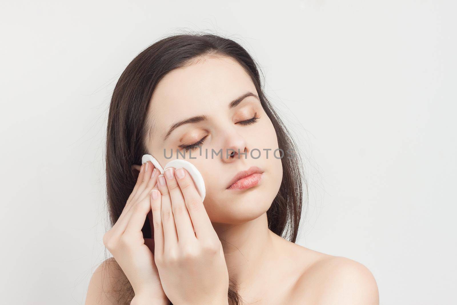 brunette bare shoulders cosmetics skincare cropped view. High quality photo