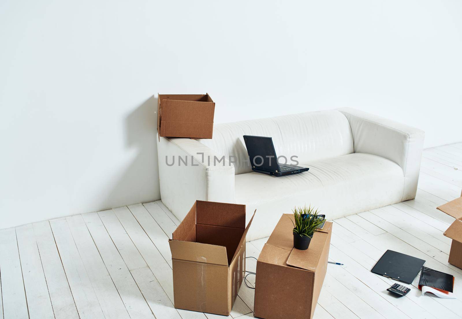 Boxes with things white sofa unpacking office moving. High quality photo