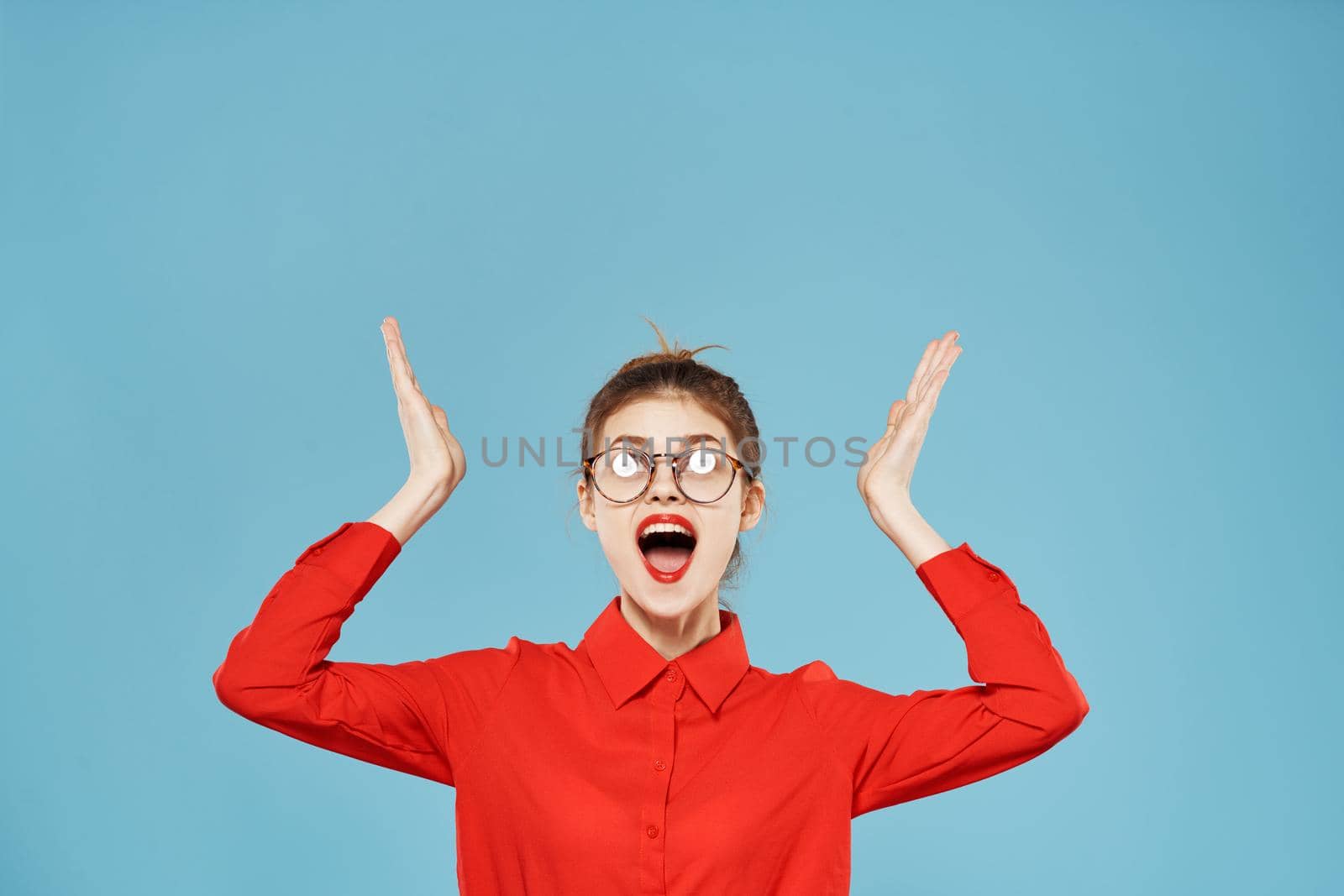 Business woman in red shirt emotions secretary working office blue background. High quality photo