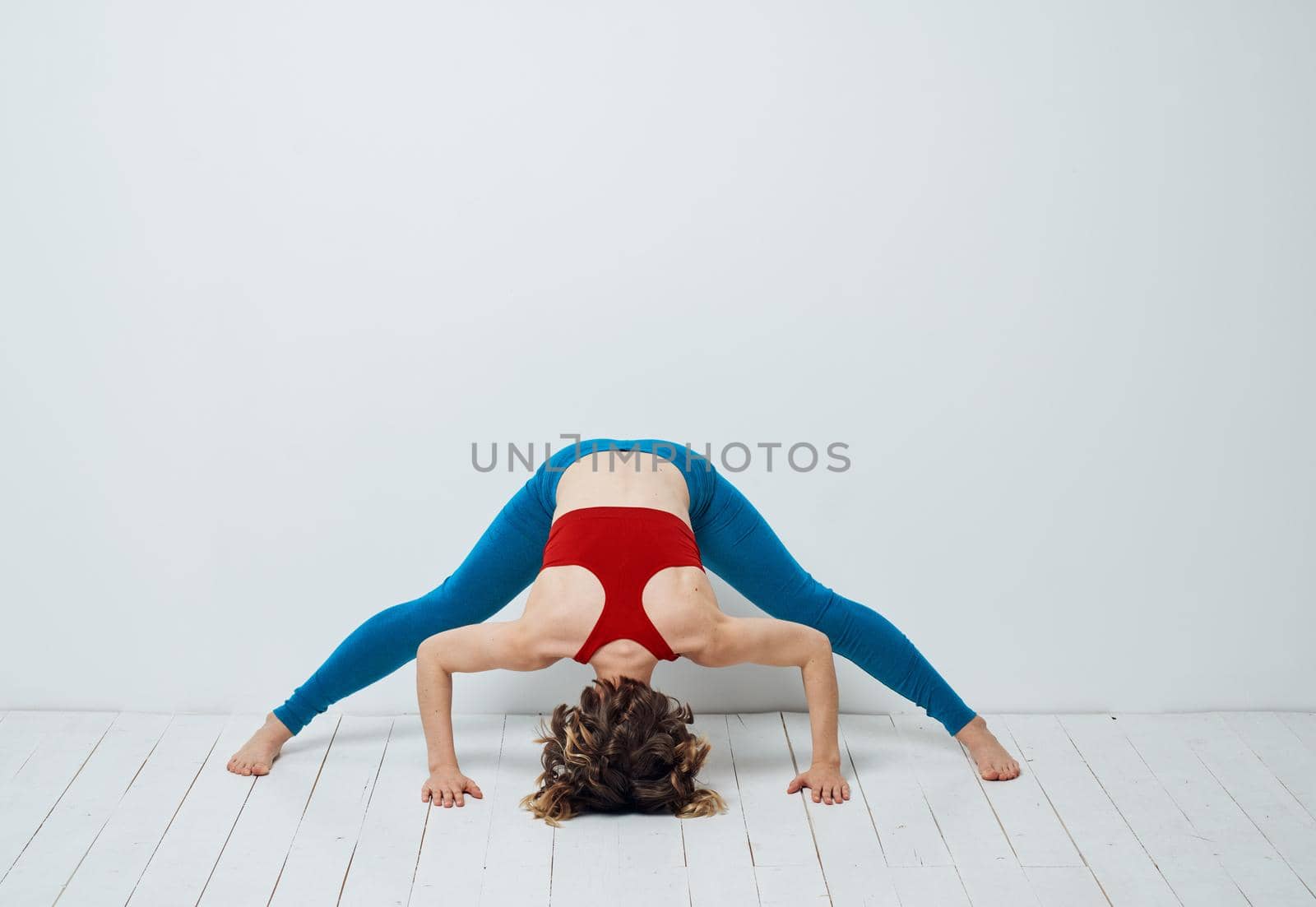 woman I leaned forward on the wooden floor Yoga Sport Fitness Asana by SHOTPRIME