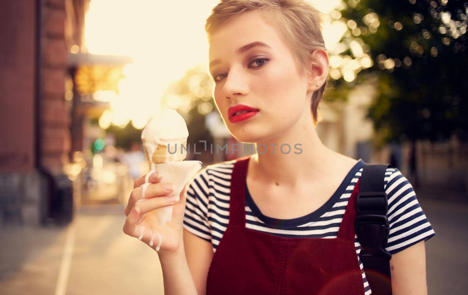 pretty woman with short hair eating ice cream outdoors leisure walk. High quality photo